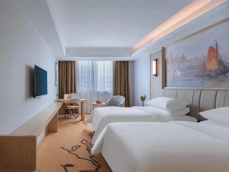 Bed in Vienna Hotel Yangzhou Gaoyou Dongfangyujing