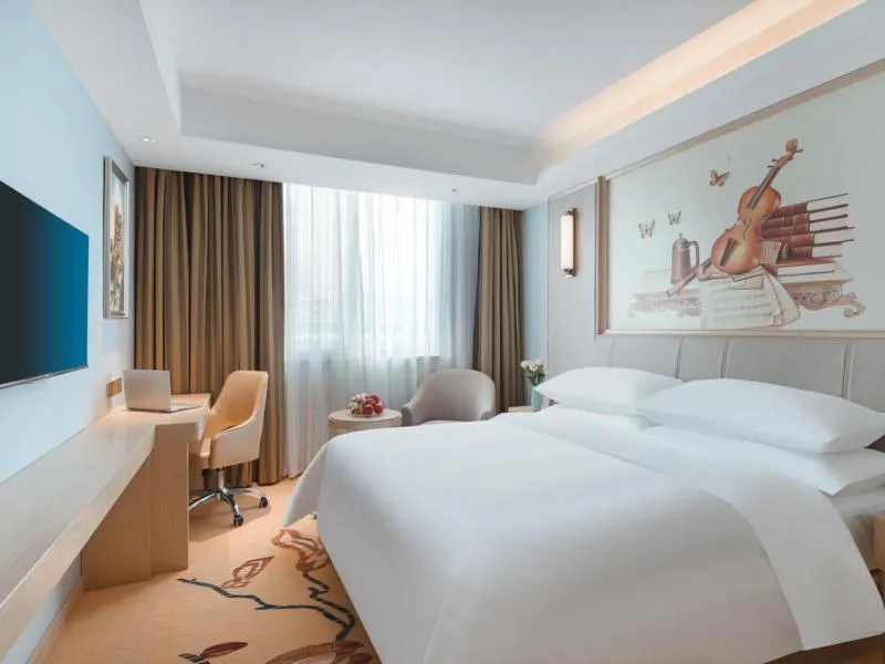 Bed in Vienna Hotel Yangzhou Gaoyou Dongfangyujing