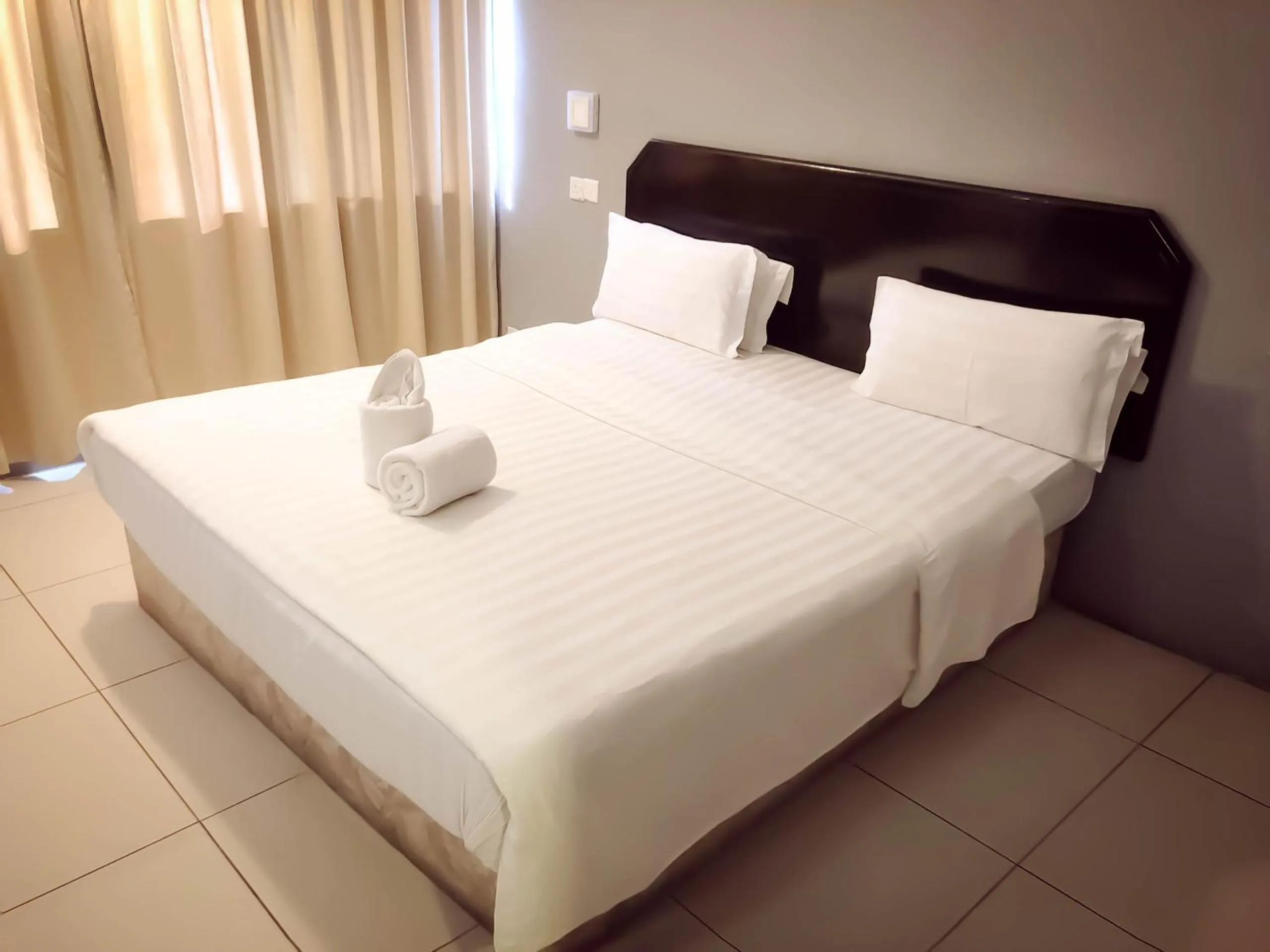 Bed in De Choice Hotel Tawau