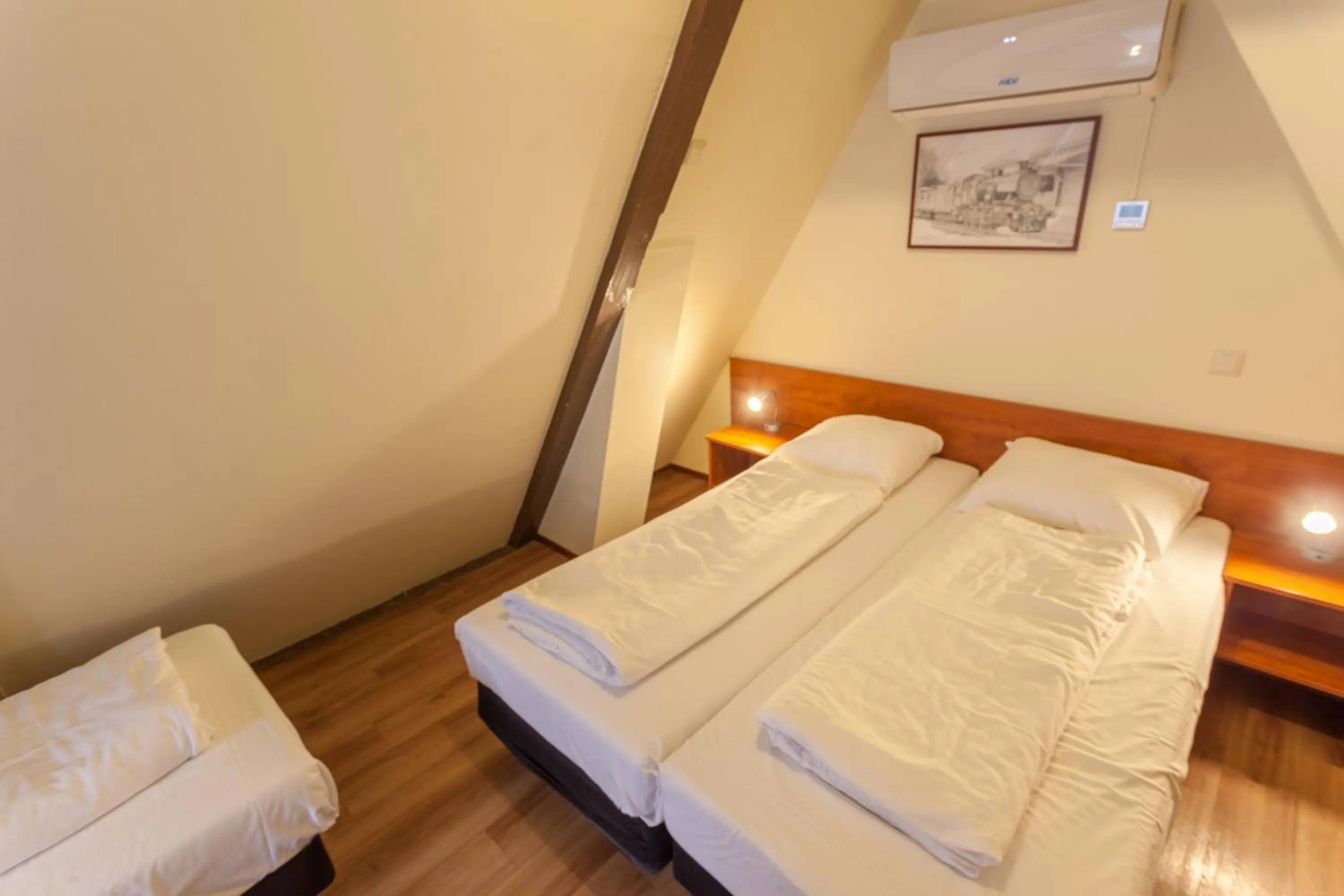 Bed in A-Train Hotel