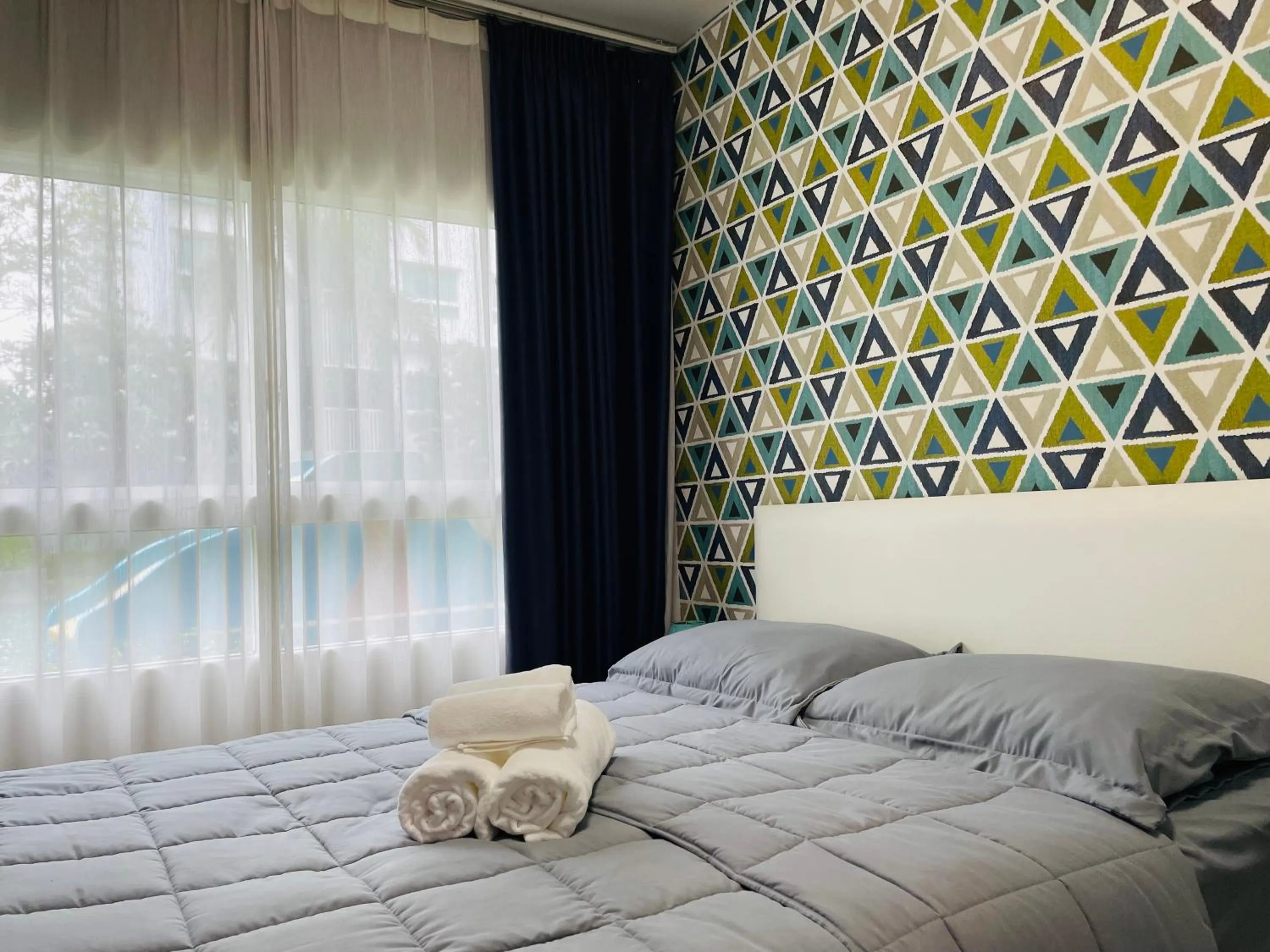 Bed in The Trust Condo by the Sea