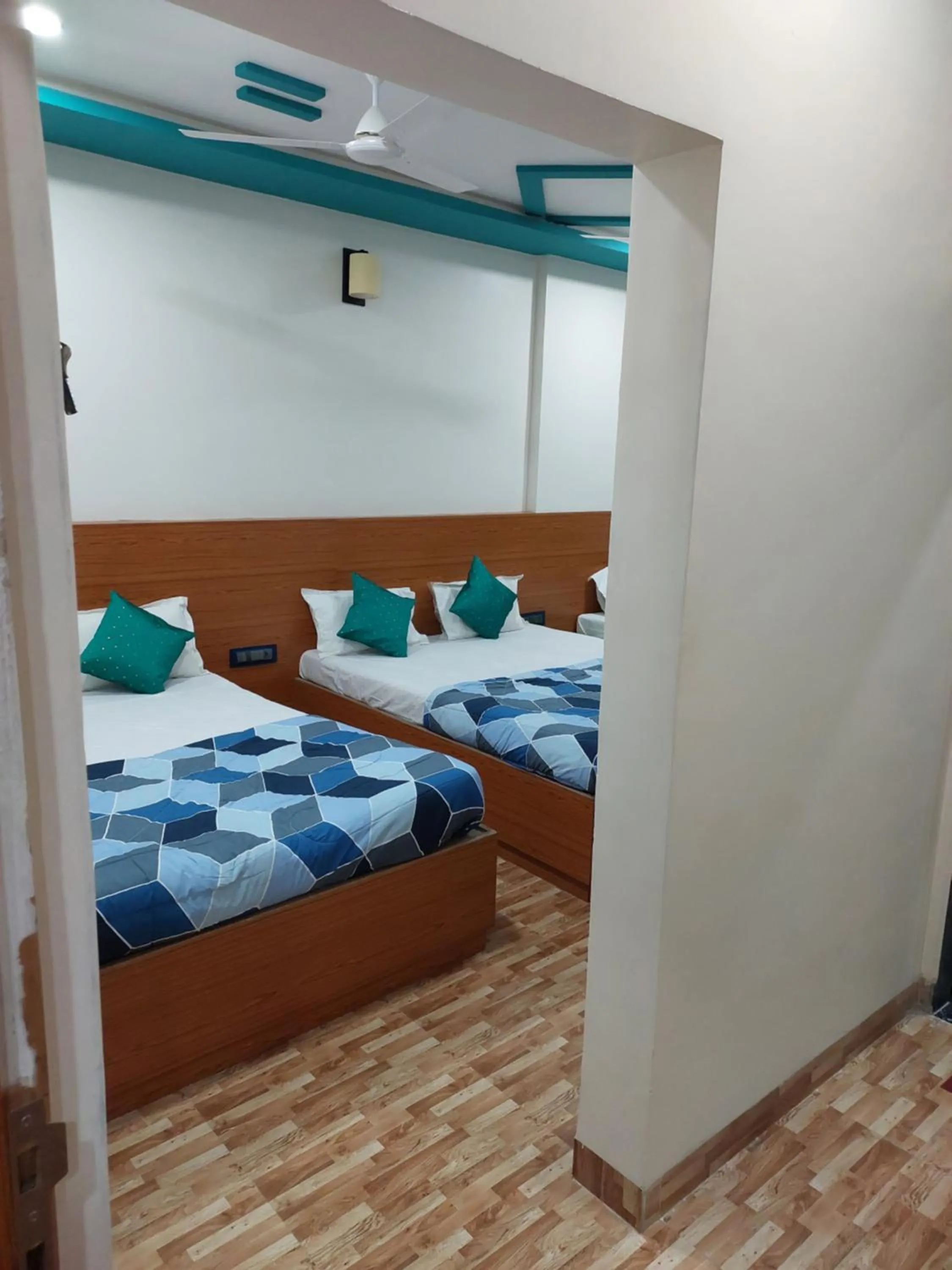 Bed in Hotel Sai Dakshina Inn & The Fern Restaurant