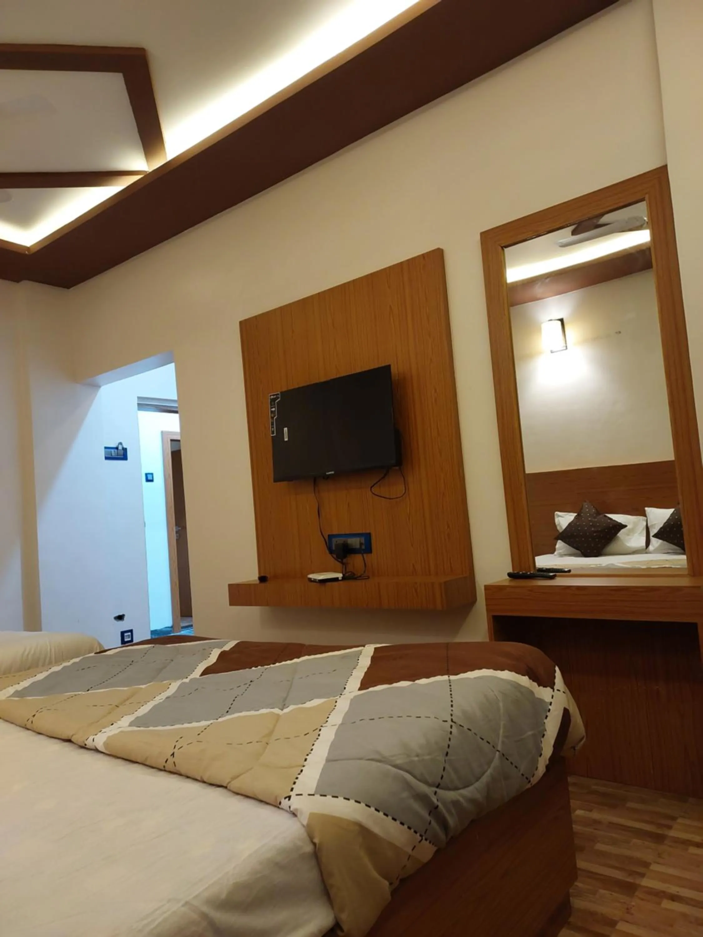 Bed in Hotel Sai Dakshina Inn & The Fern Restaurant