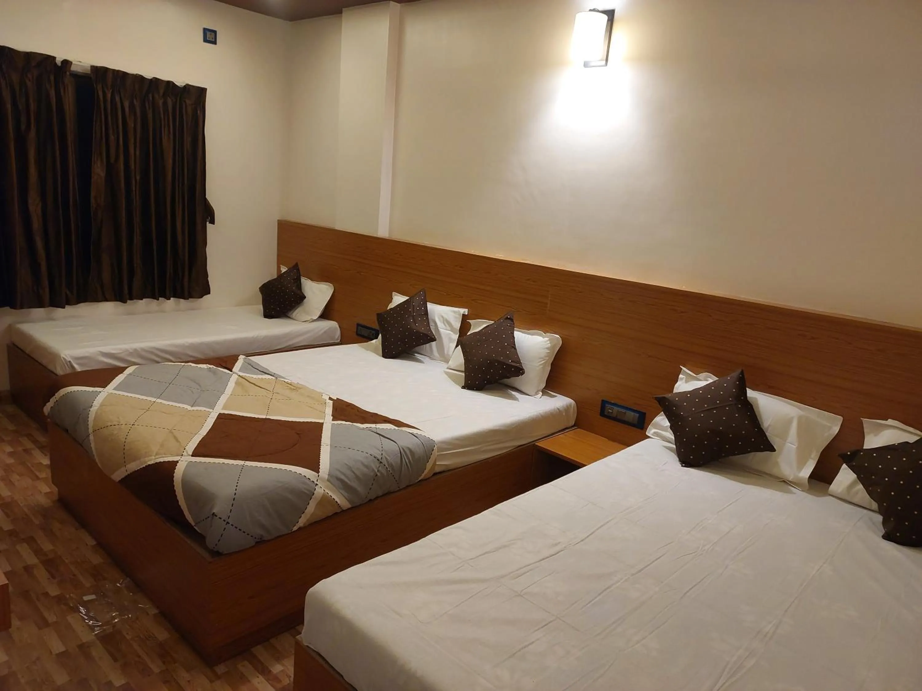 Bed in Hotel Sai Dakshina Inn & The Fern Restaurant