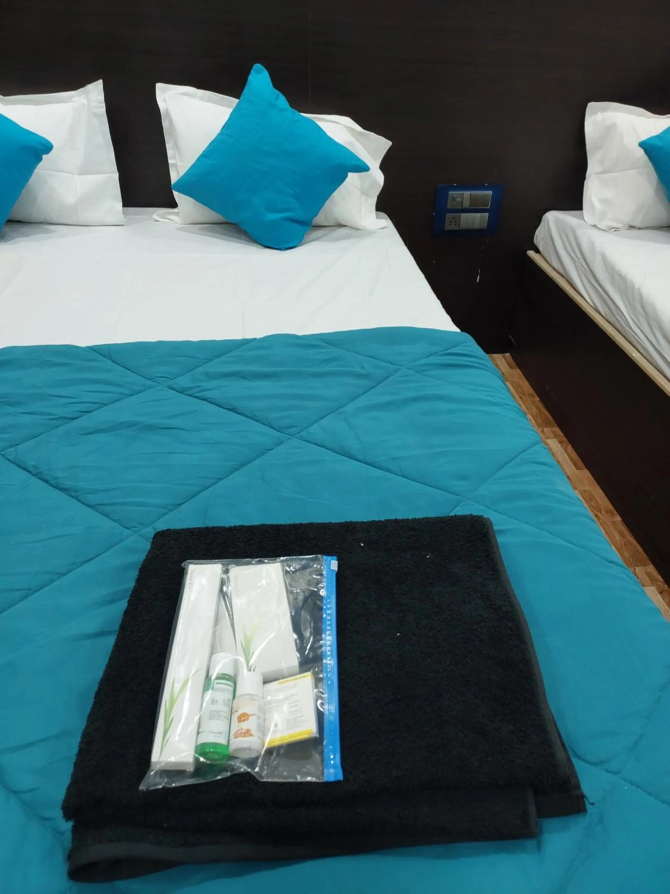 Bed in Hotel Sai Dakshina Inn & The Fern Restaurant