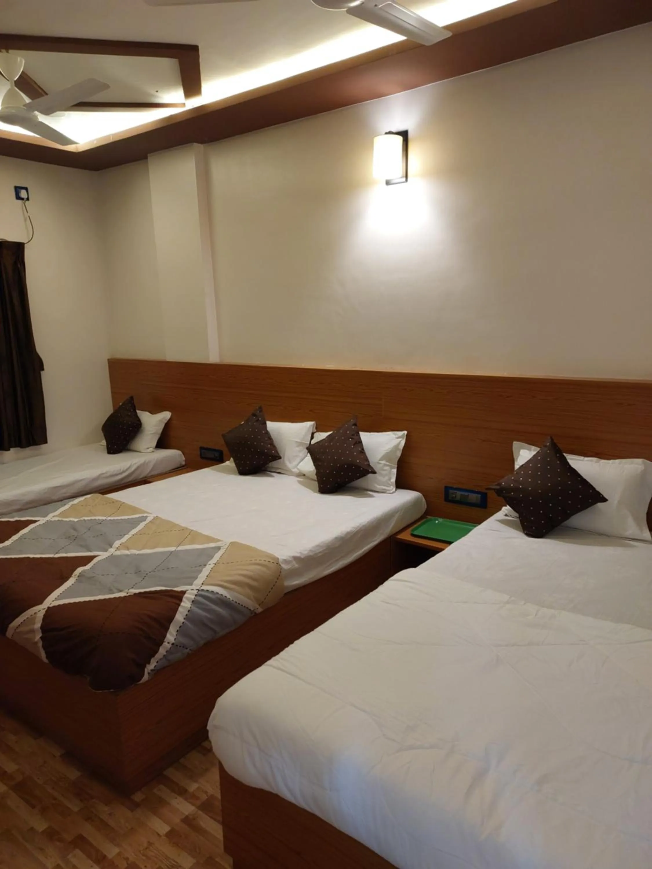 Bed in Hotel Sai Dakshina Inn & The Fern Restaurant