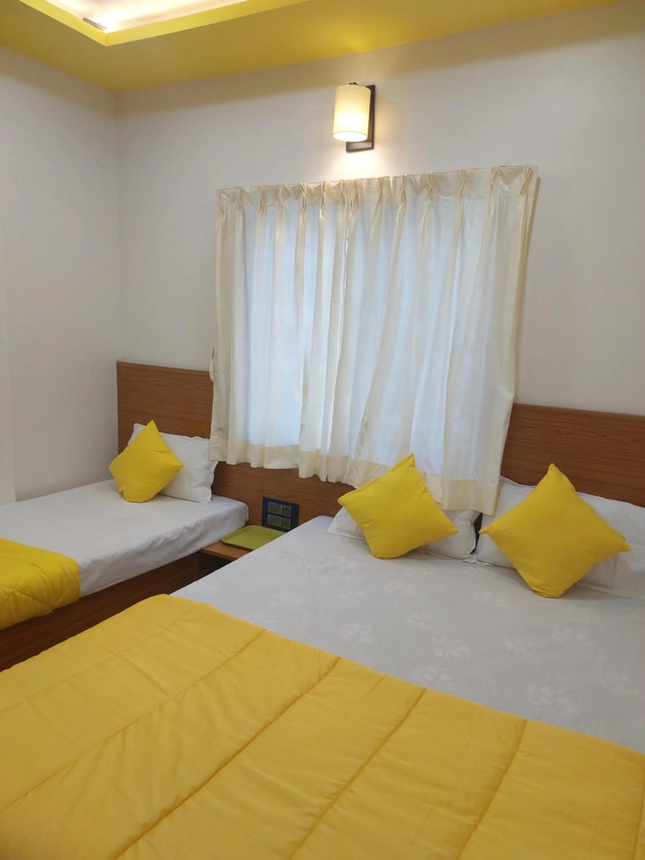 Bed in Hotel Sai Dakshina Inn & The Fern Restaurant