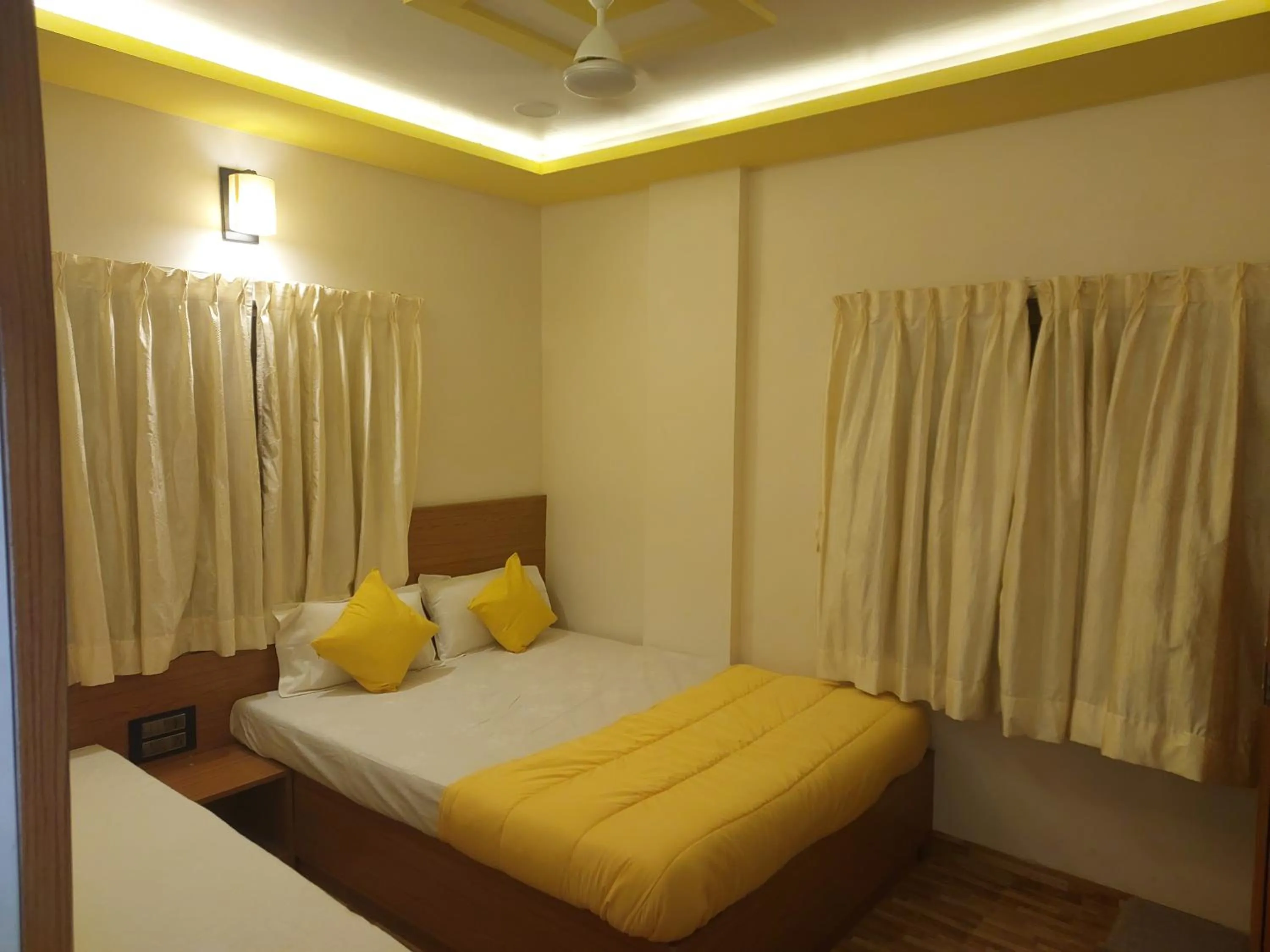 Photo of the whole room, Bed in Hotel Sai Dakshina Inn & The Fern Restaurant