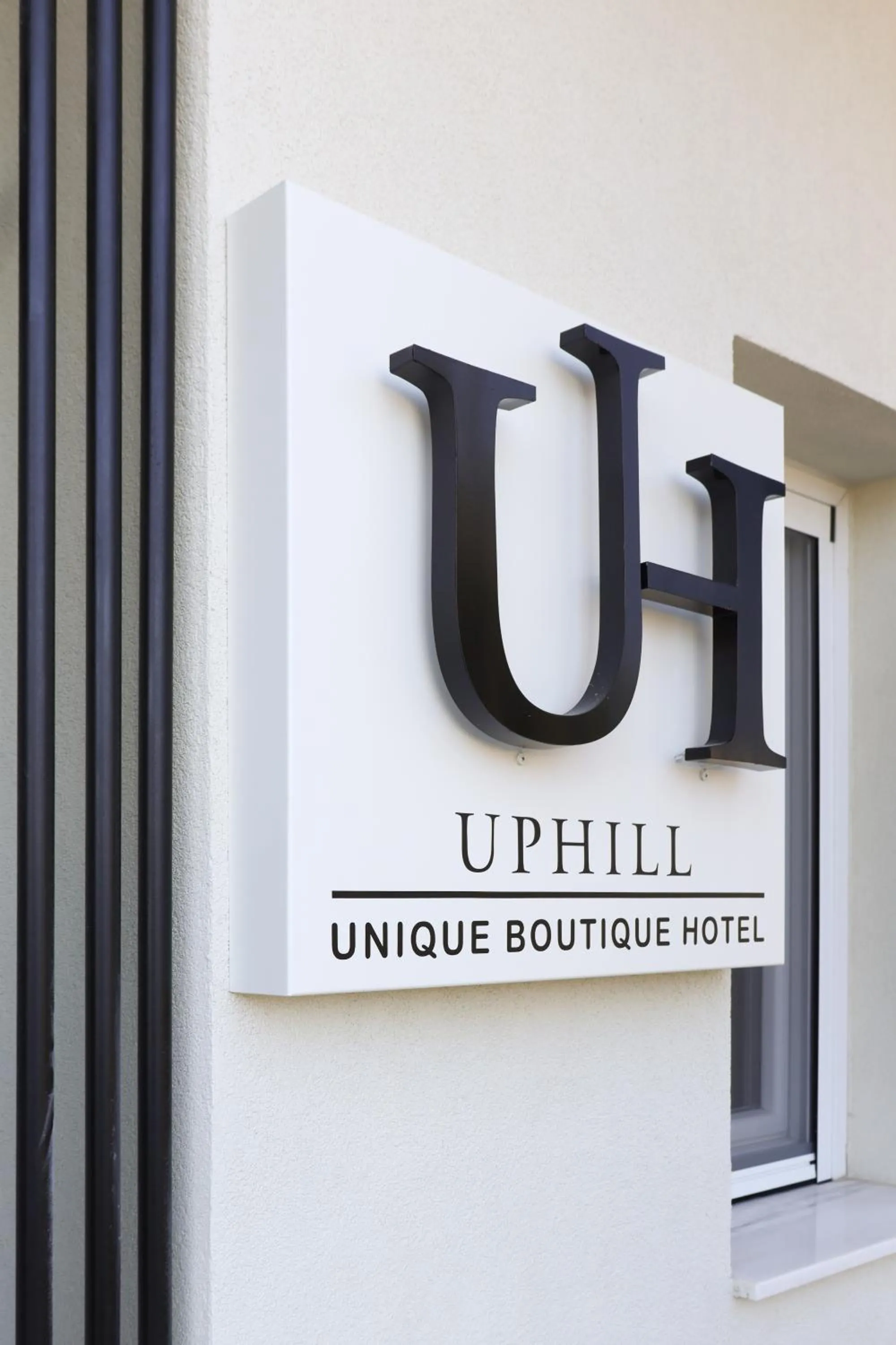 Logo/Certificate/Sign in Uphill Unique Boutique Suites
