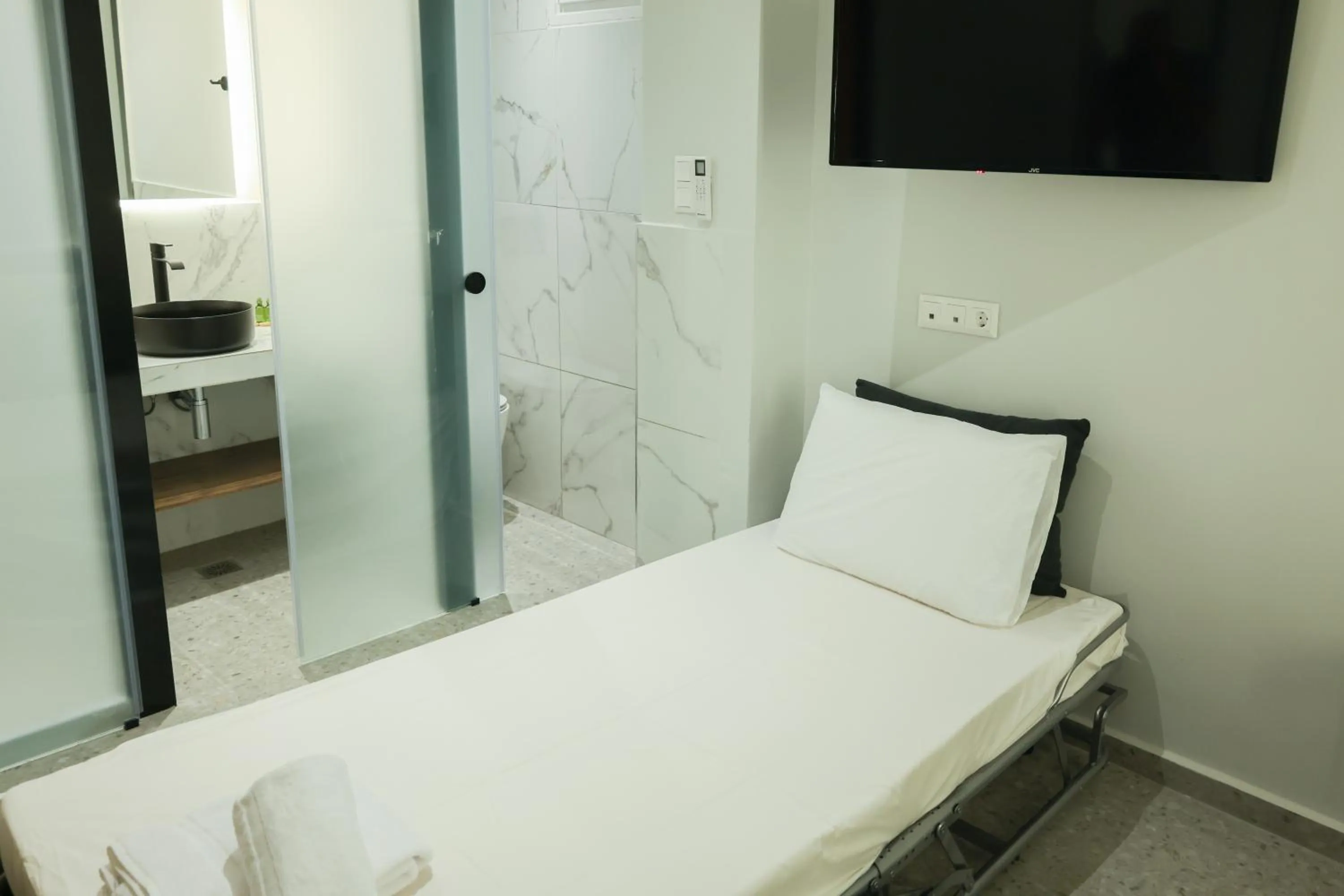 Bed in Uphill Unique Boutique Suites