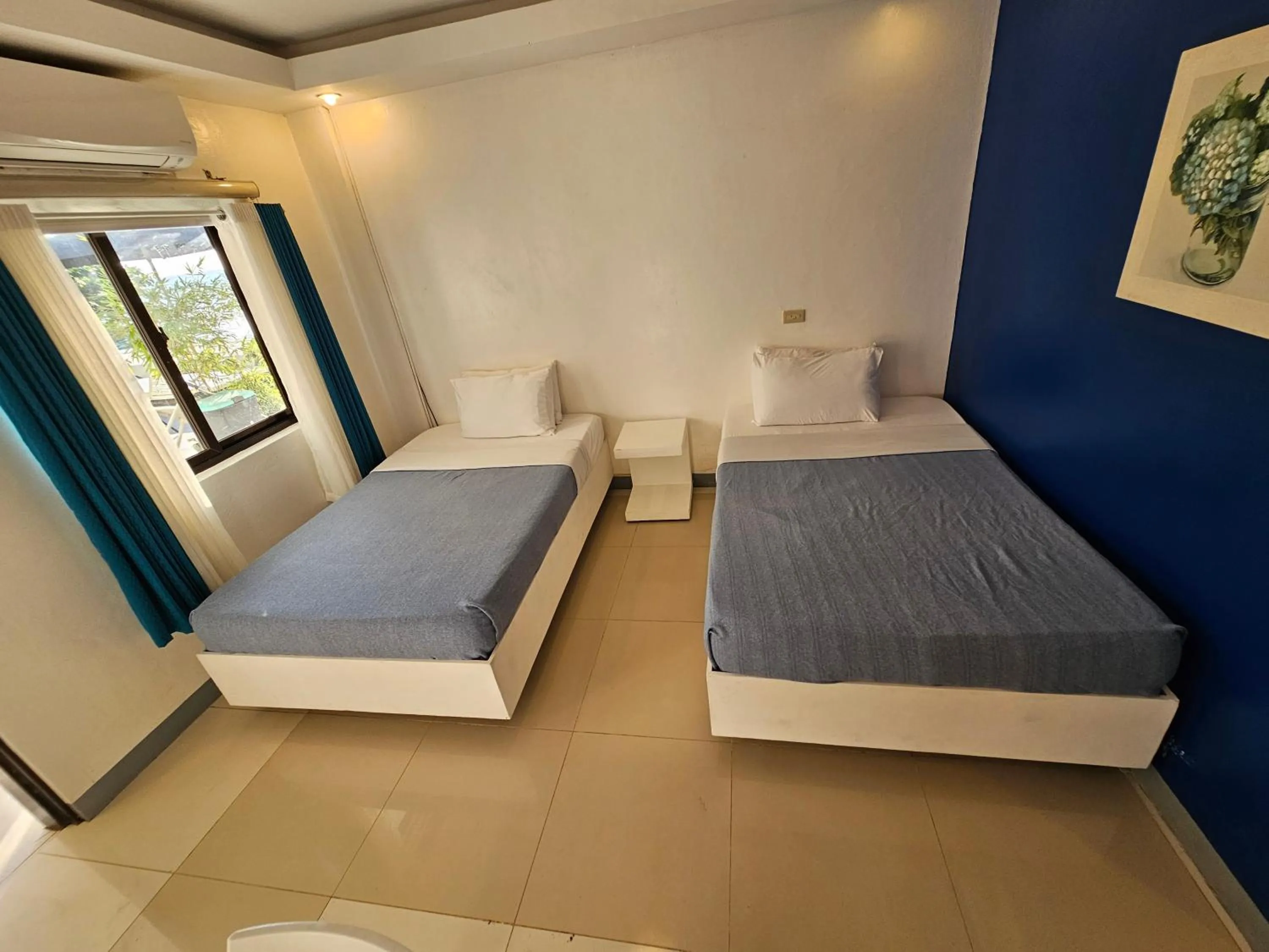 Bed in Blue Coast Beach Hotel