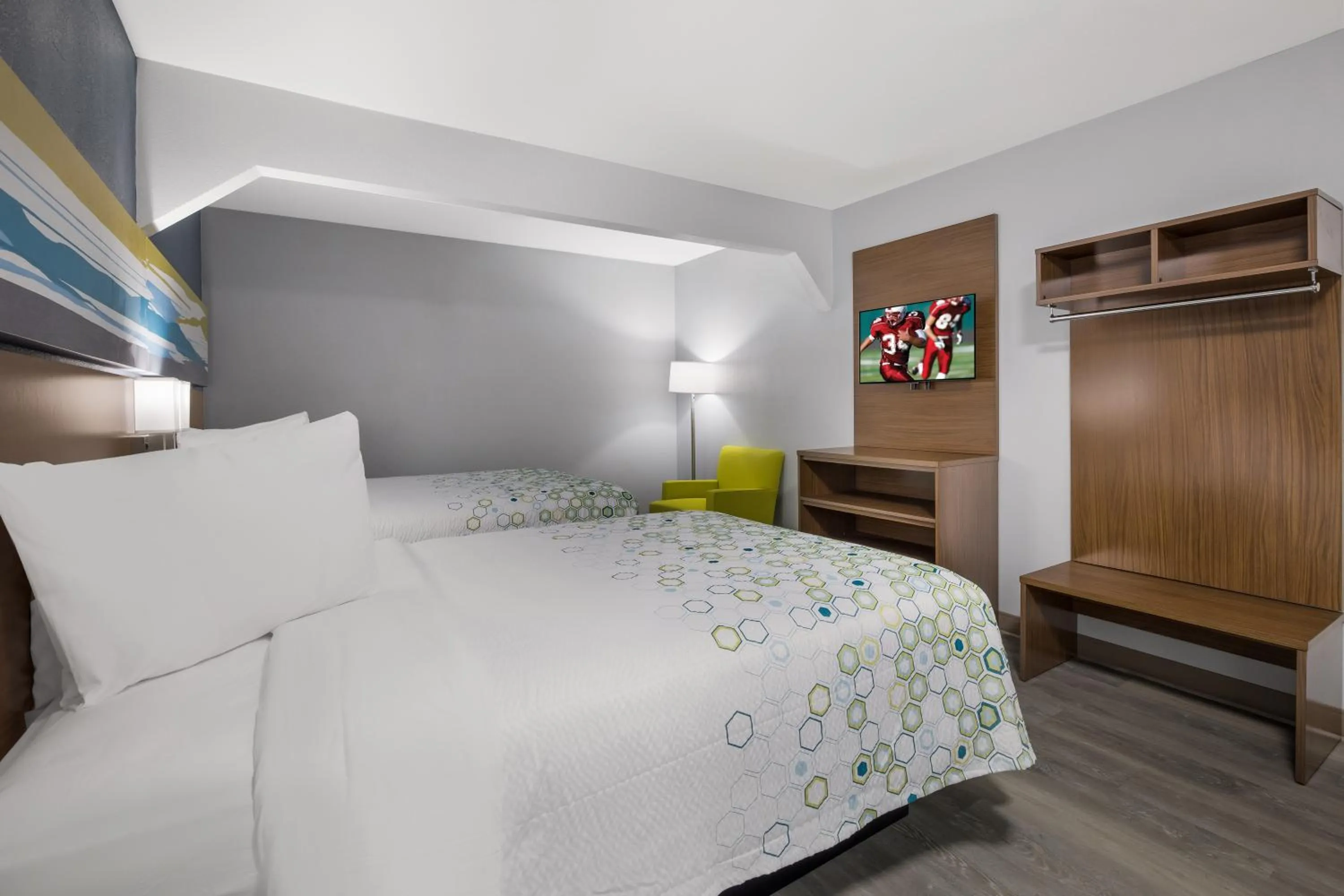 Bed in HomeTowne Studios by Red Roof Orange, TX