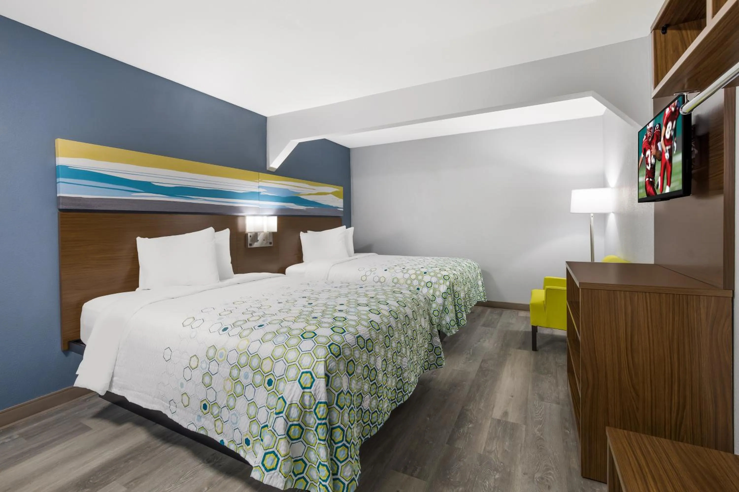 Bed in HomeTowne Studios by Red Roof Orange, TX