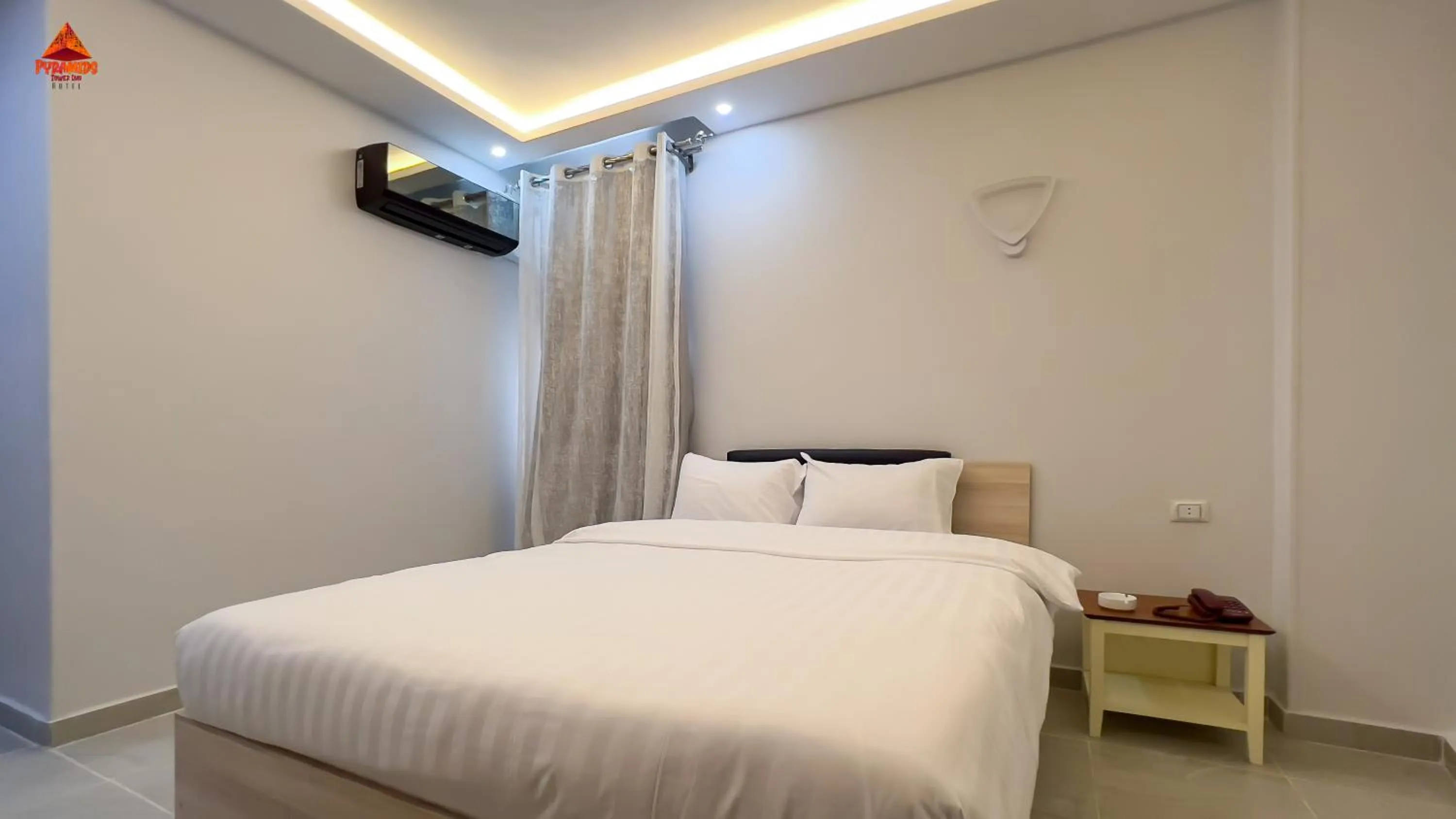 Bed in pyramids tower view inn