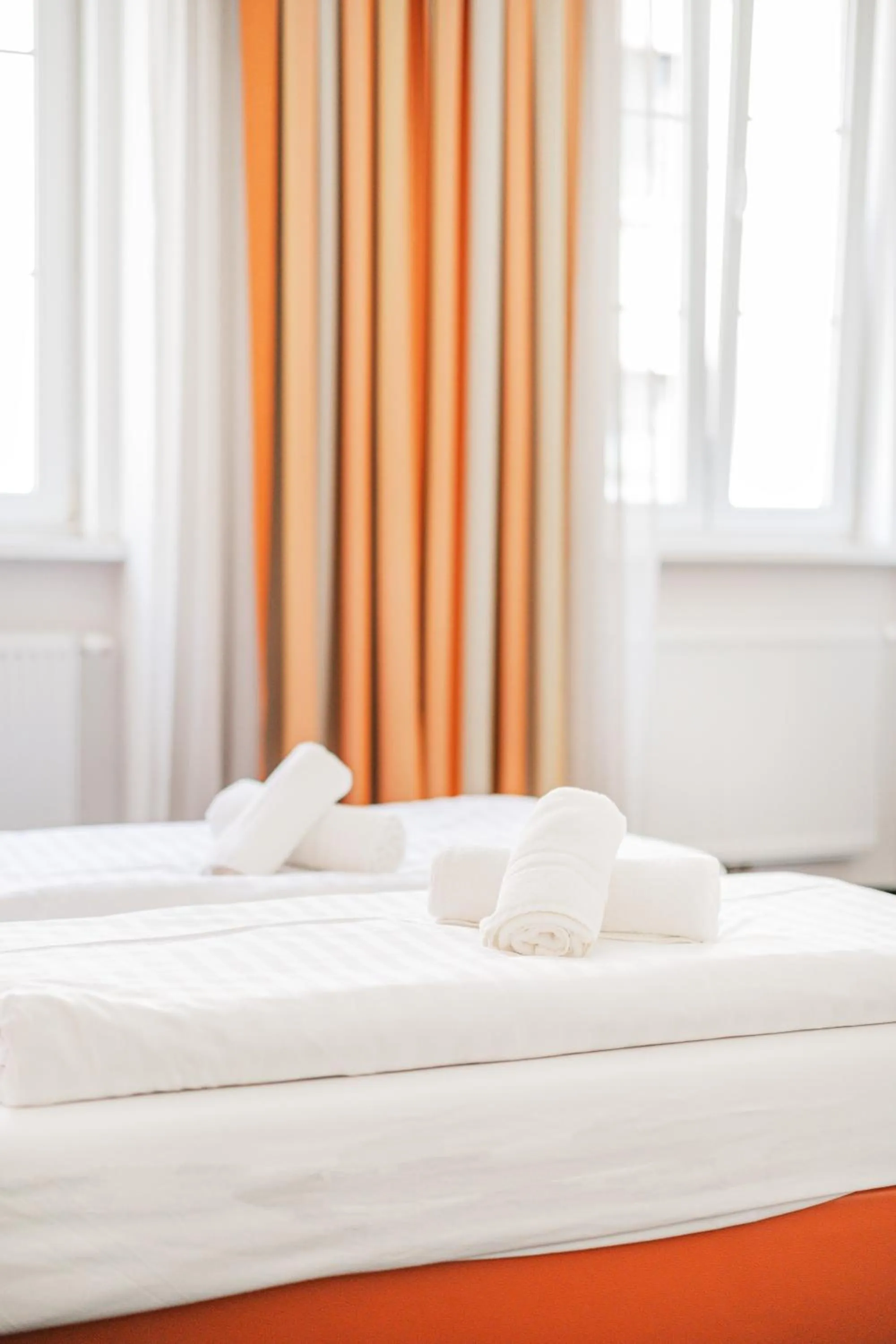 Bed in Self-Check-In Hotel Adlon