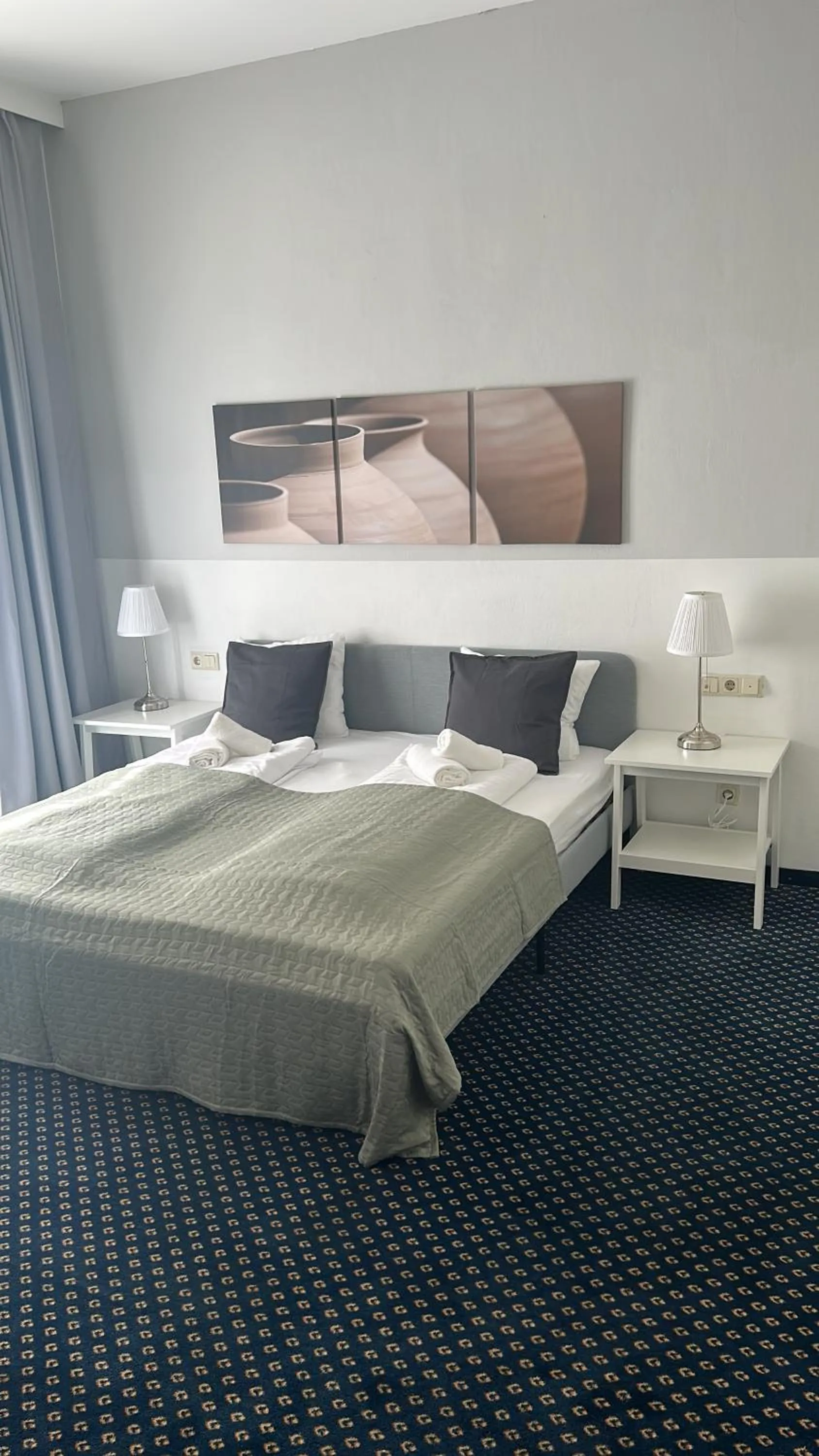 Bed in Self-Check-In Hotel Adlon