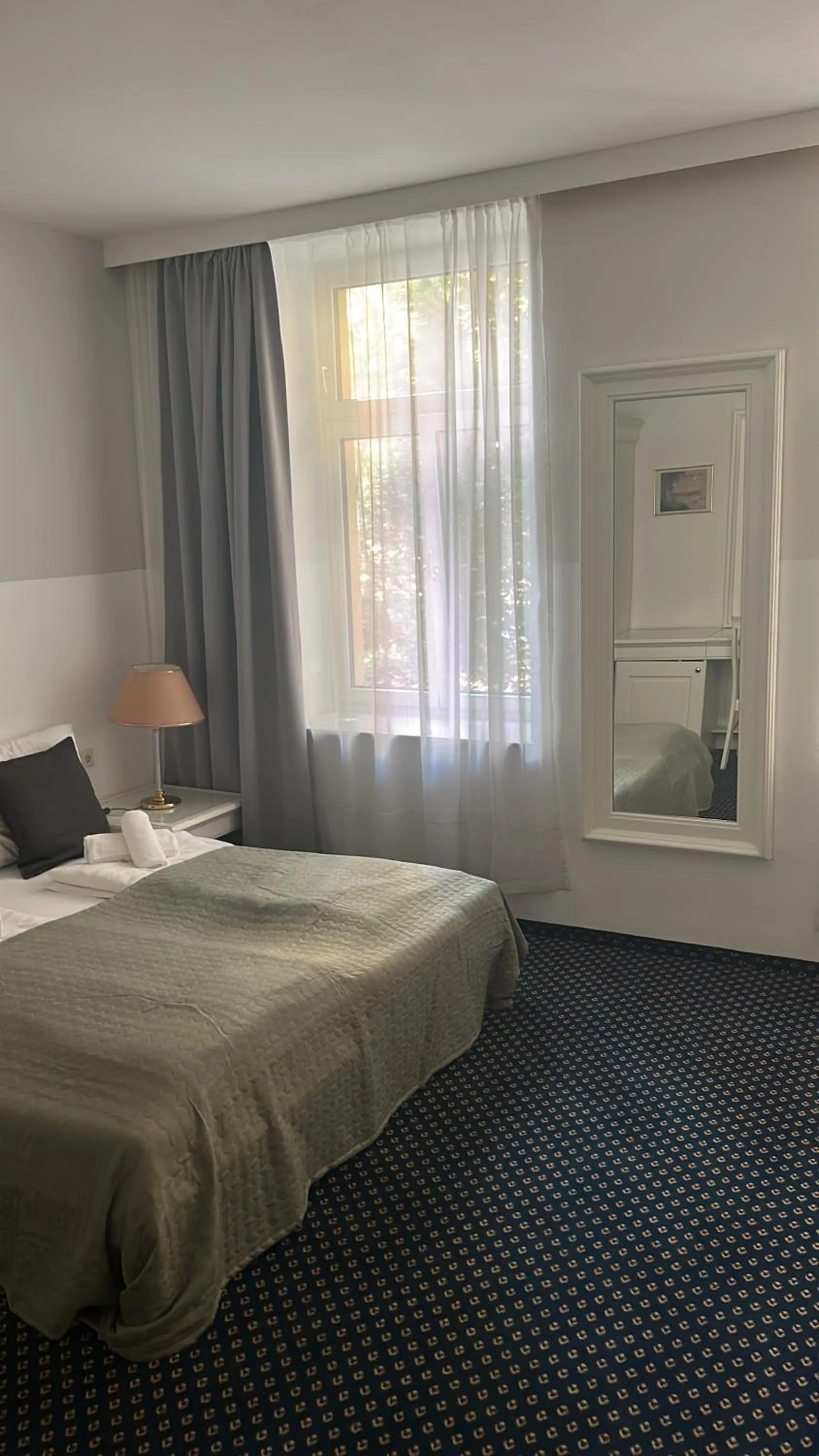 Bed in Self-Check-In Hotel Adlon
