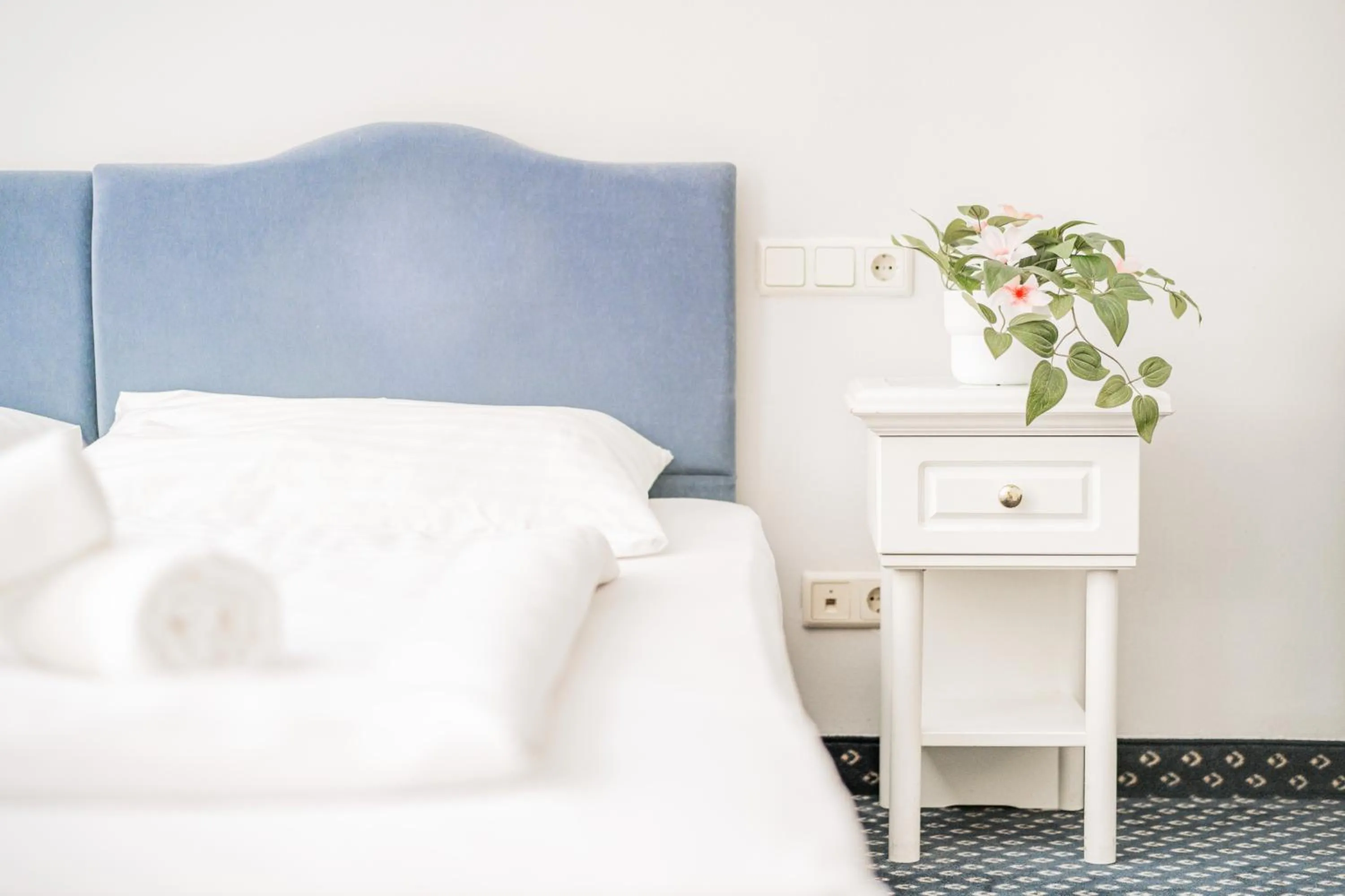 Bed in Self-Check-In Hotel Adlon