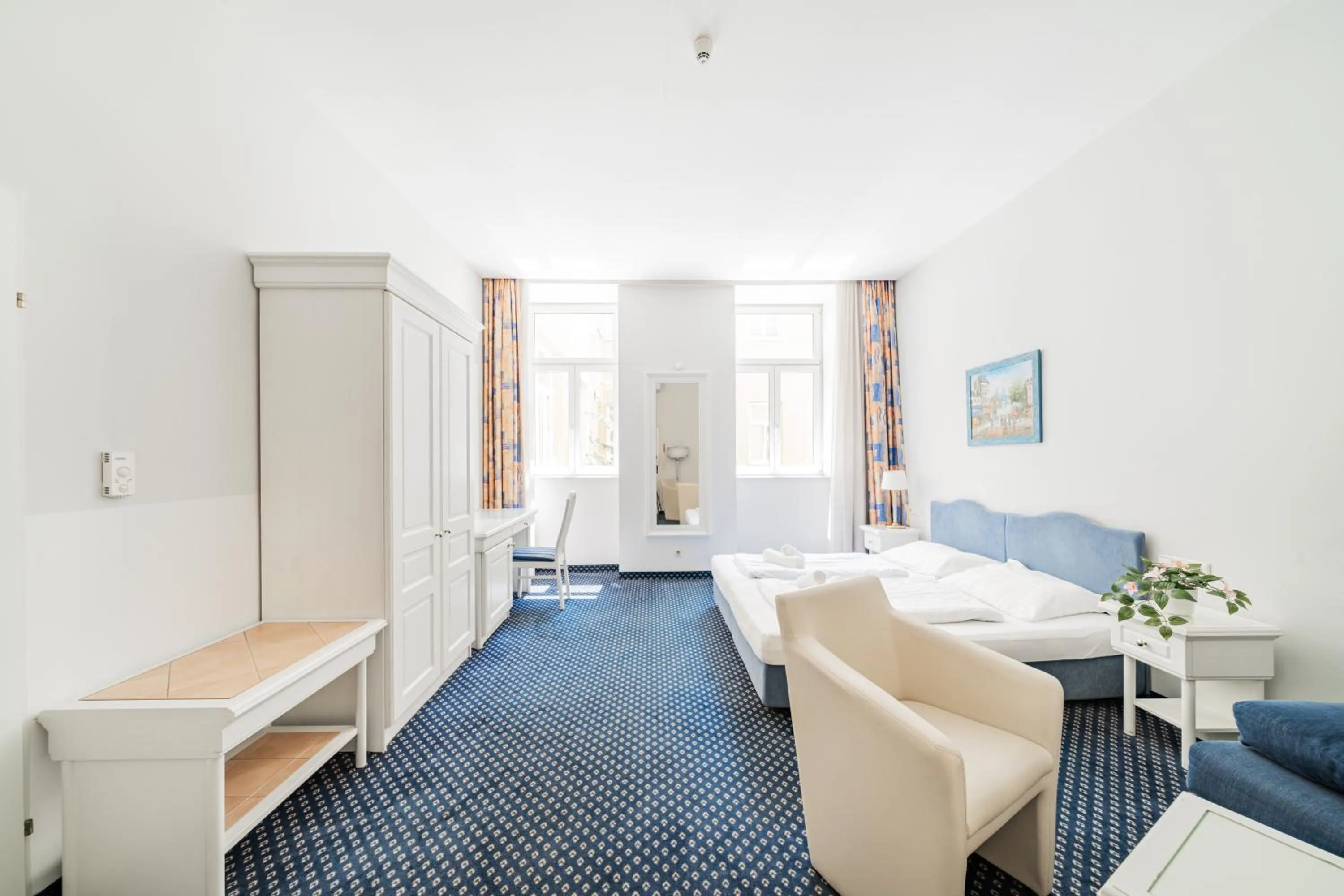 Bed in Self-Check-In Hotel Adlon