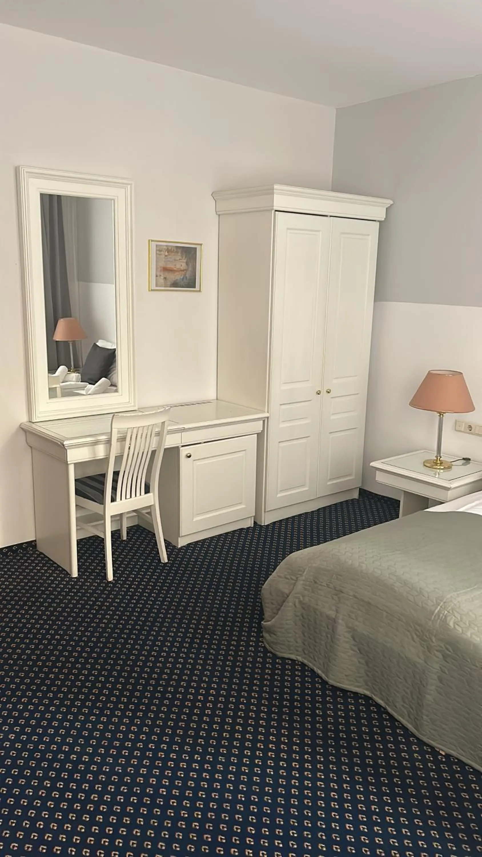 Bed in Self-Check-In Hotel Adlon