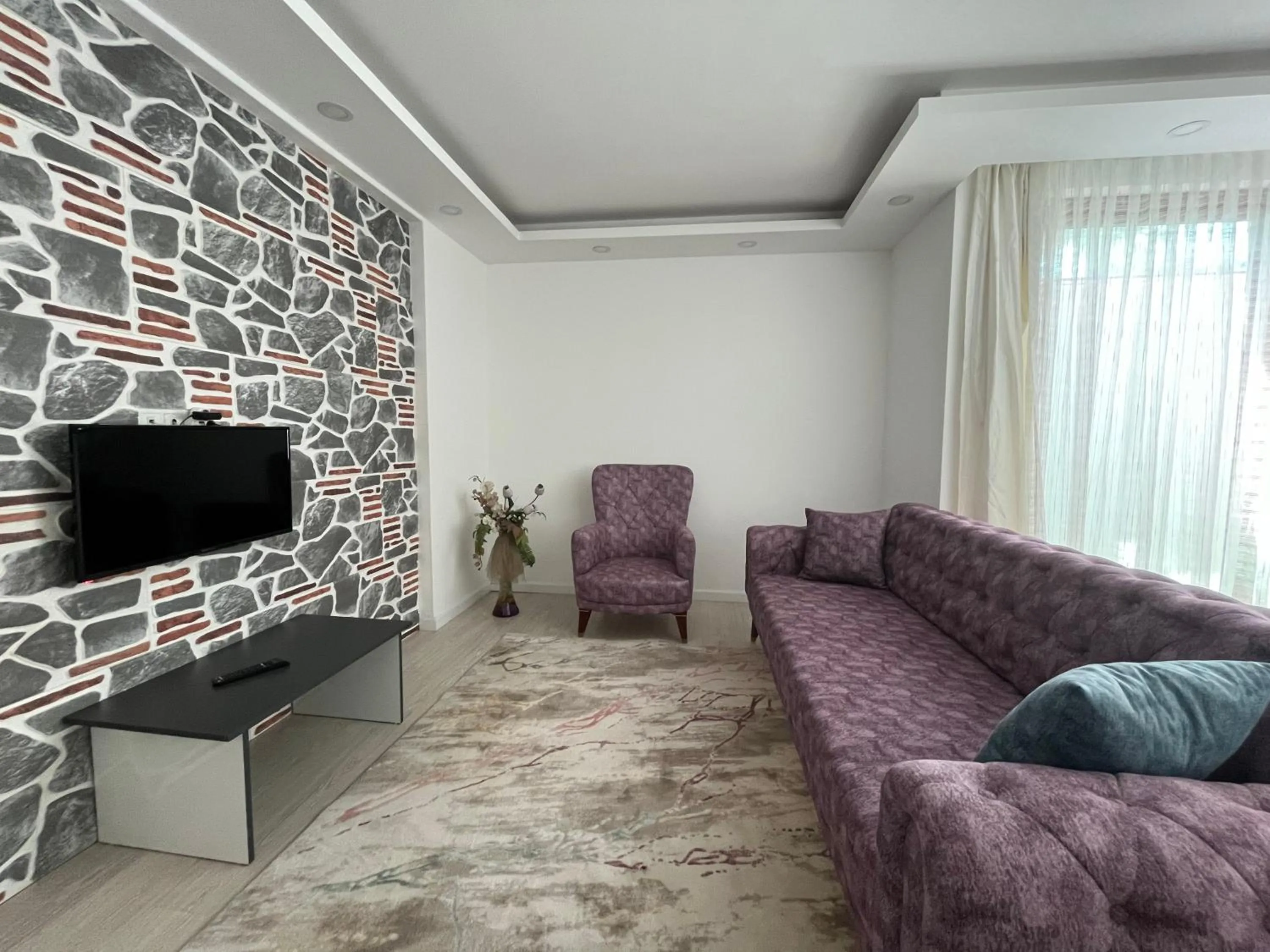 Communal lounge/ TV room in Gardenya Lara Suit Hotel