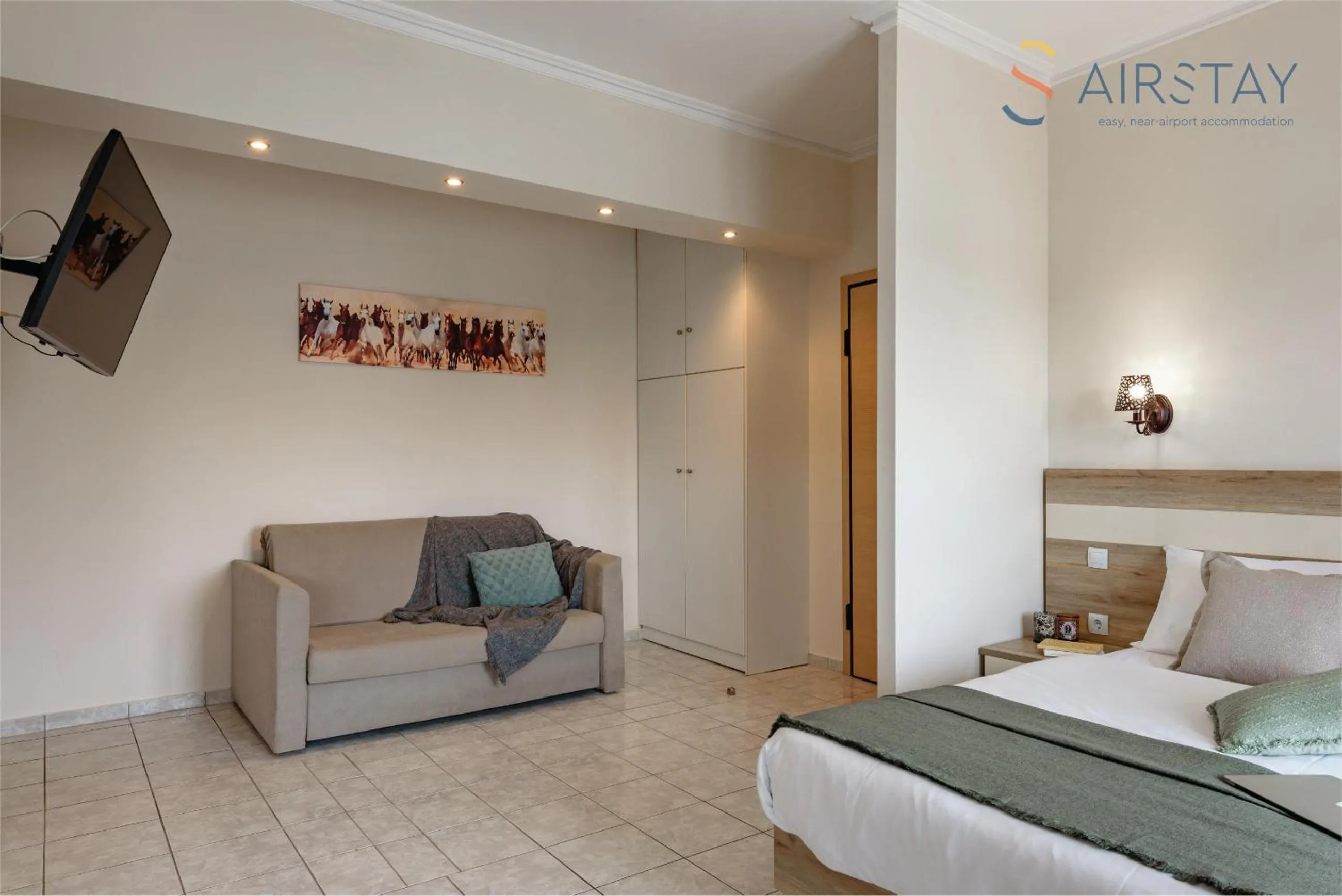 Living room, Bed in Zilean Apartments Airport by Airstay