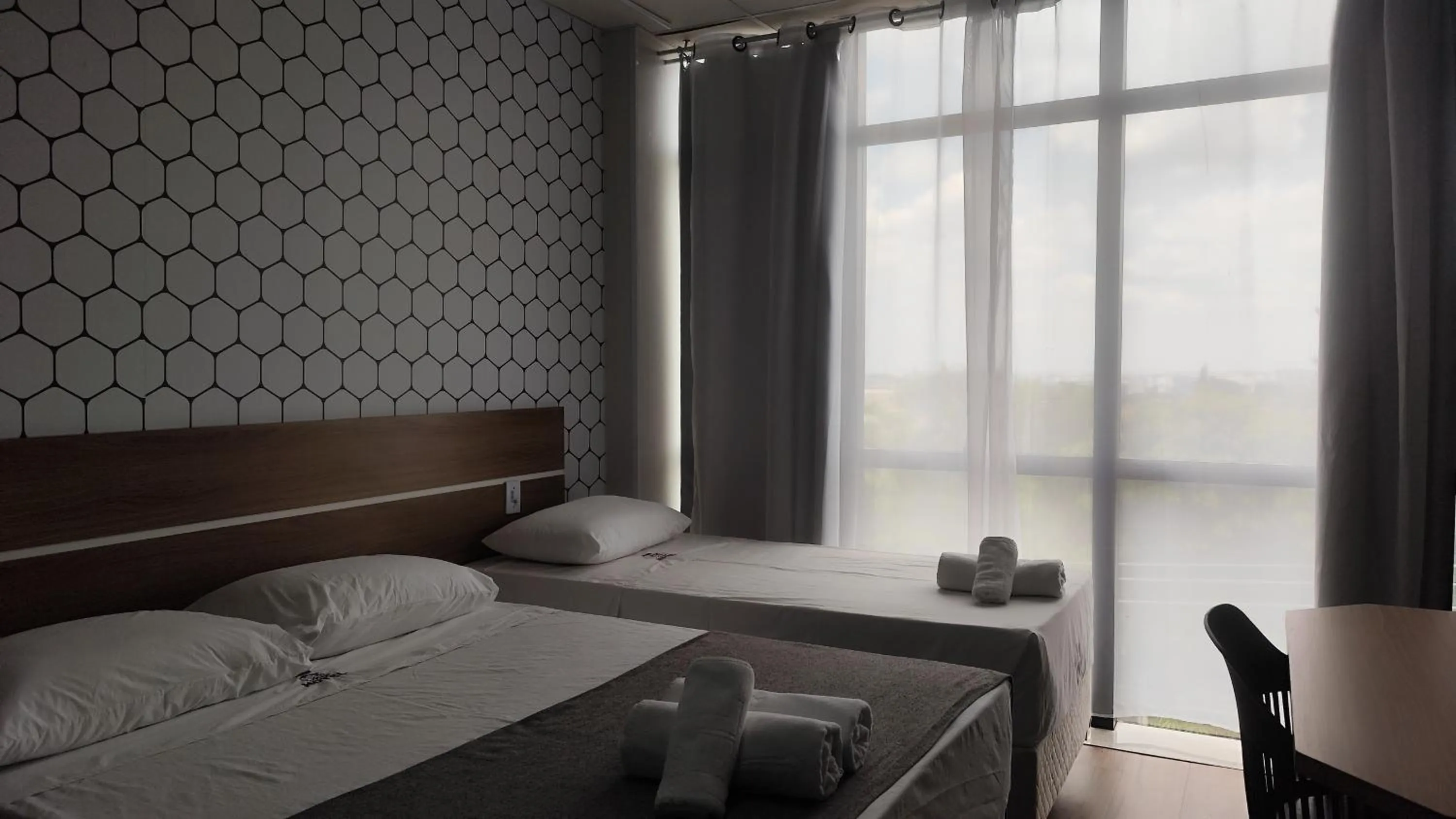 Bed in Assay Plaza Hotel