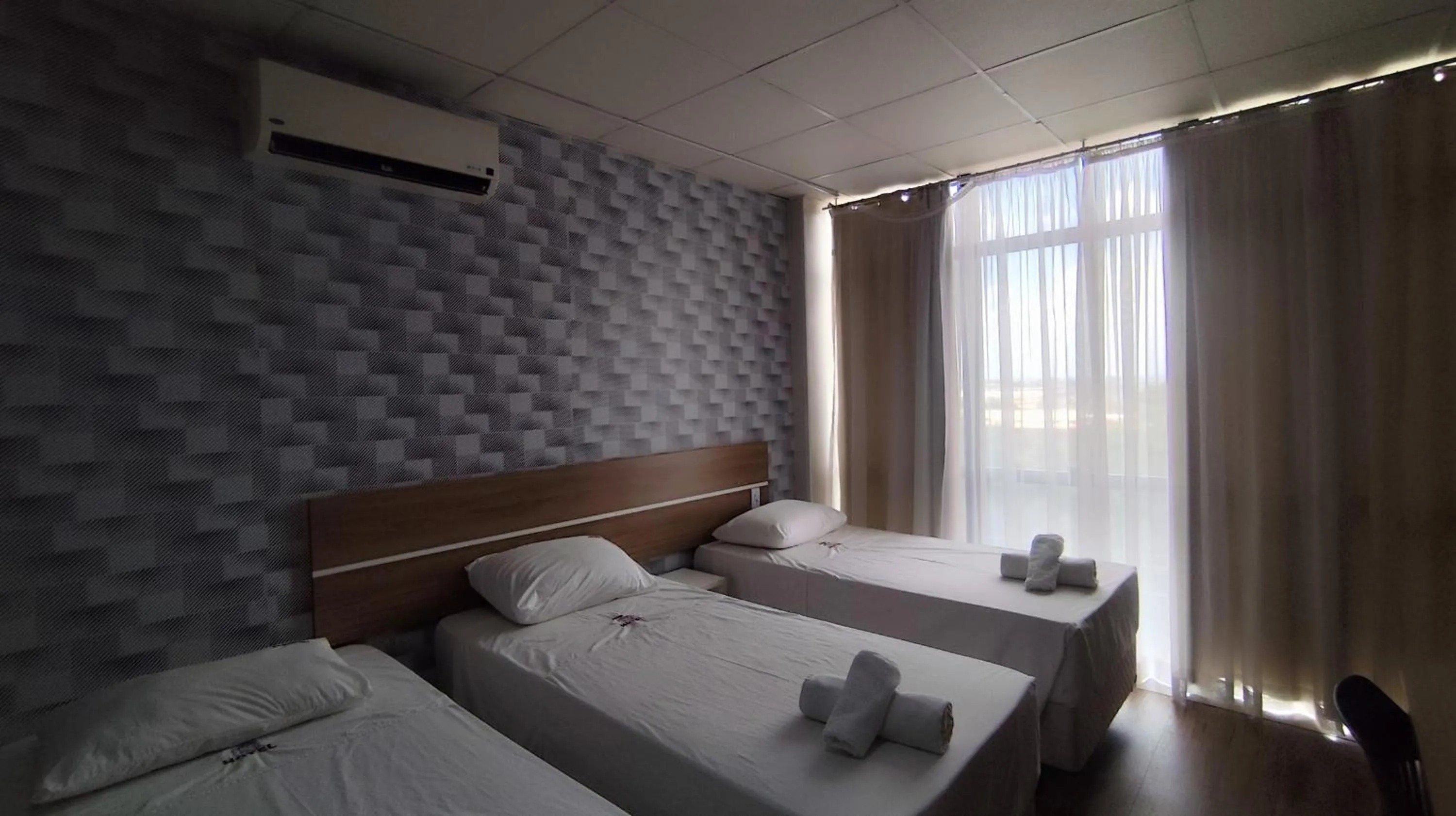 Bed in Assay Plaza Hotel