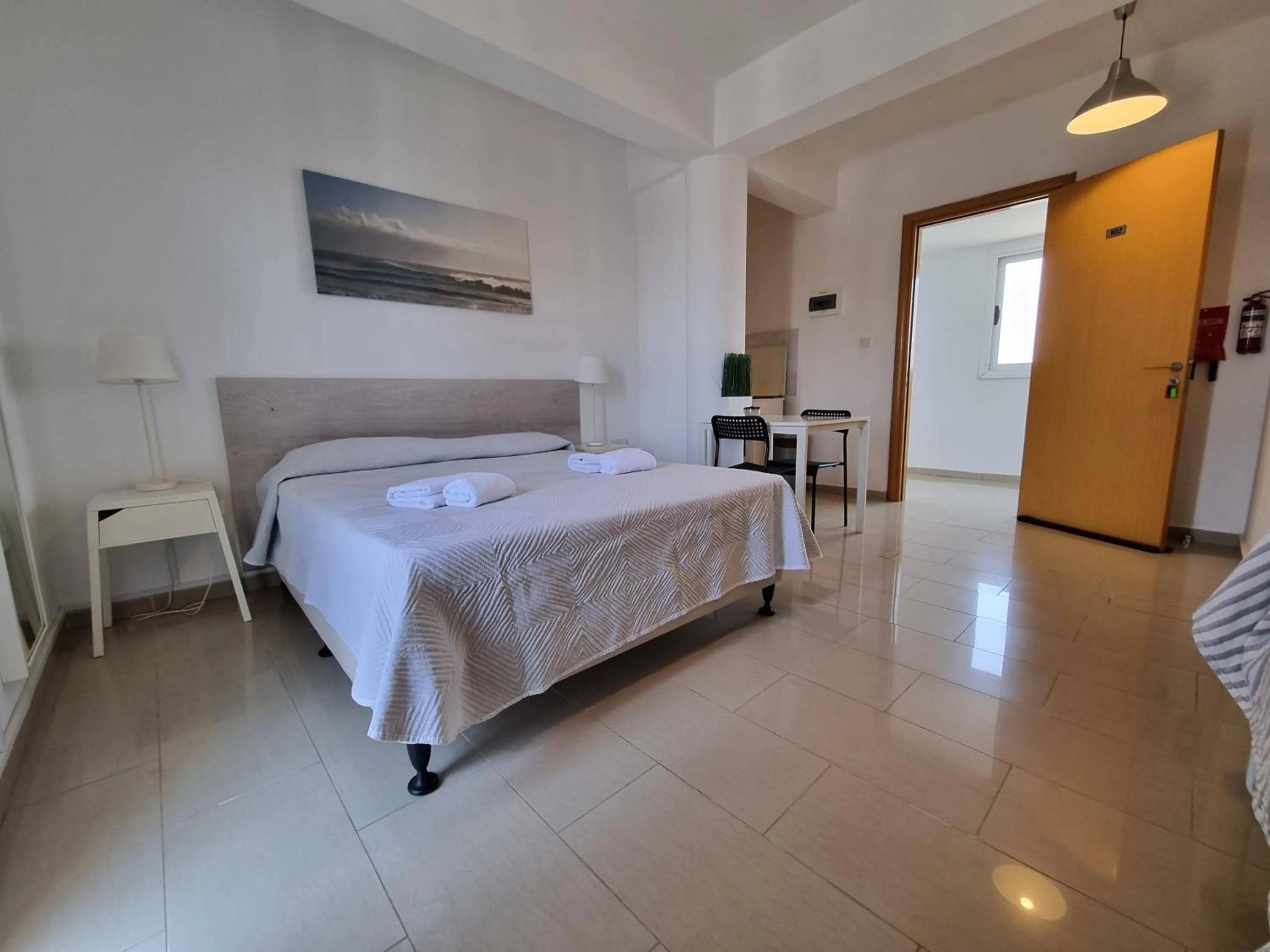 Bed in Valentinos Apartments