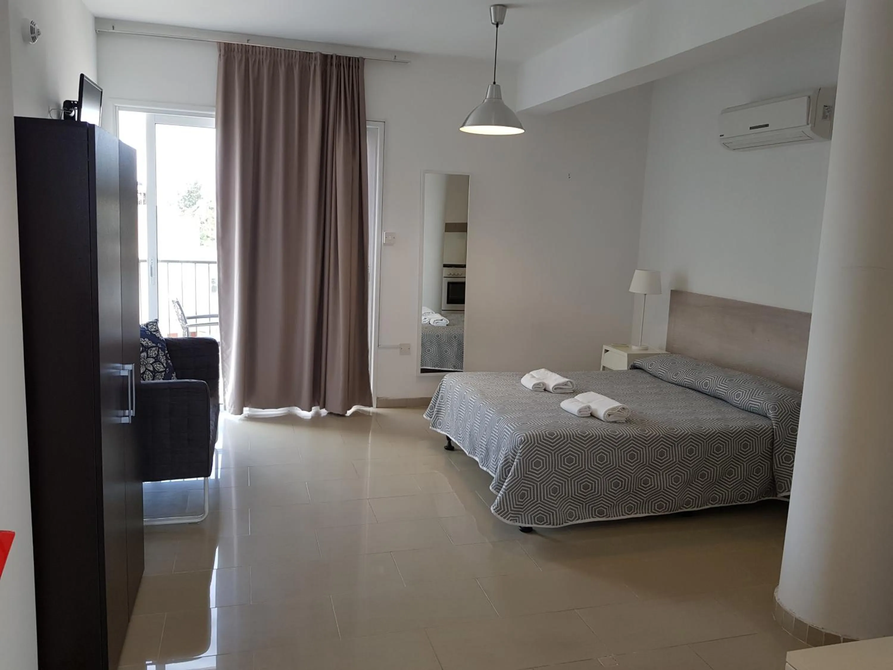 Bed in Valentinos Apartments