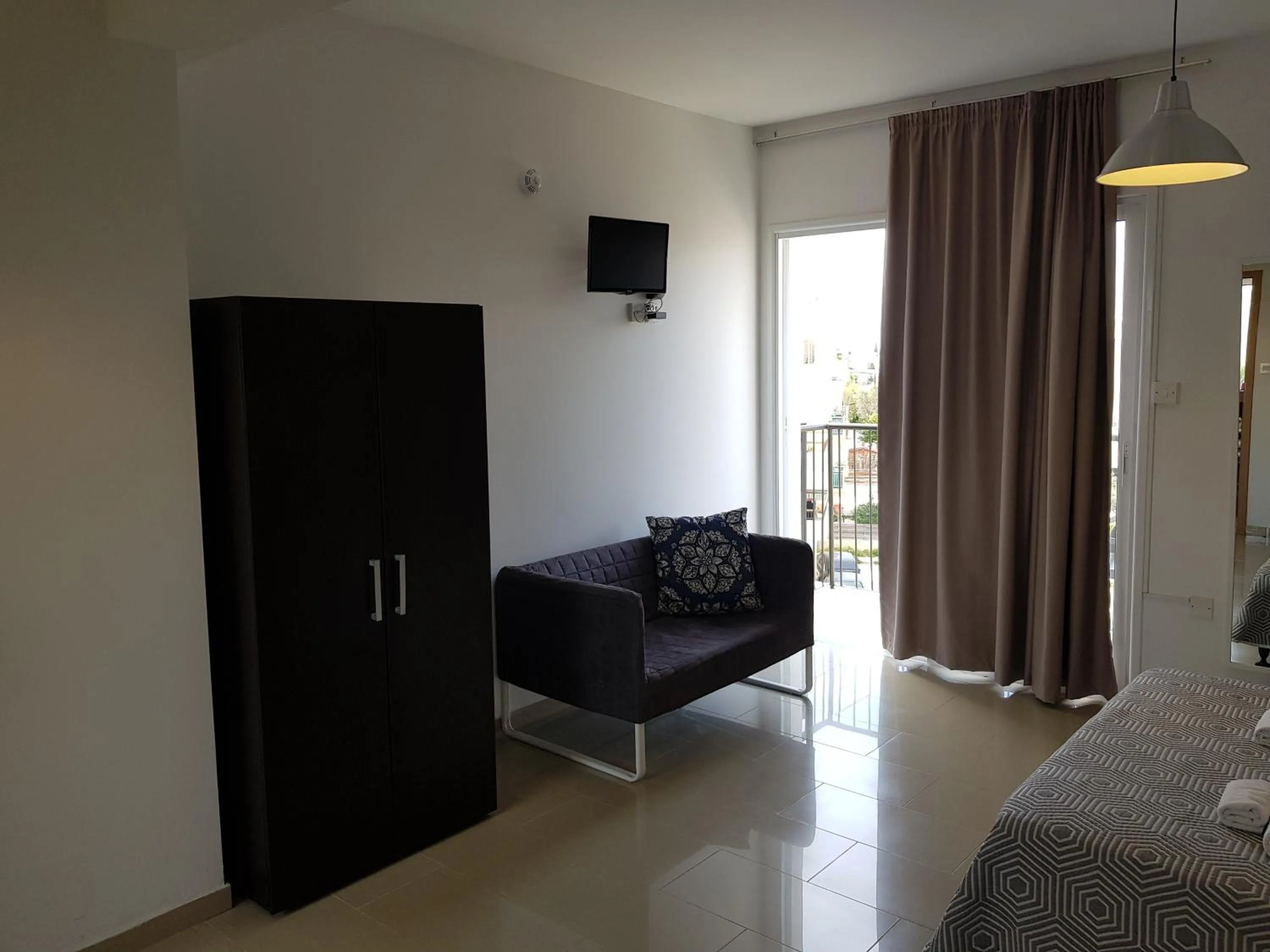 Bed in Valentinos Apartments