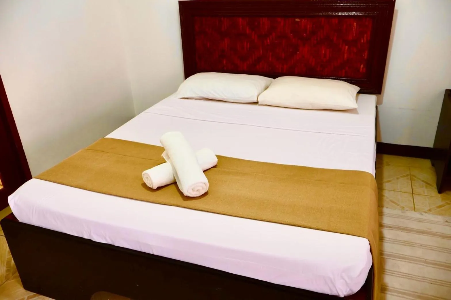 Bed in CHIISAI NATSU RESORT