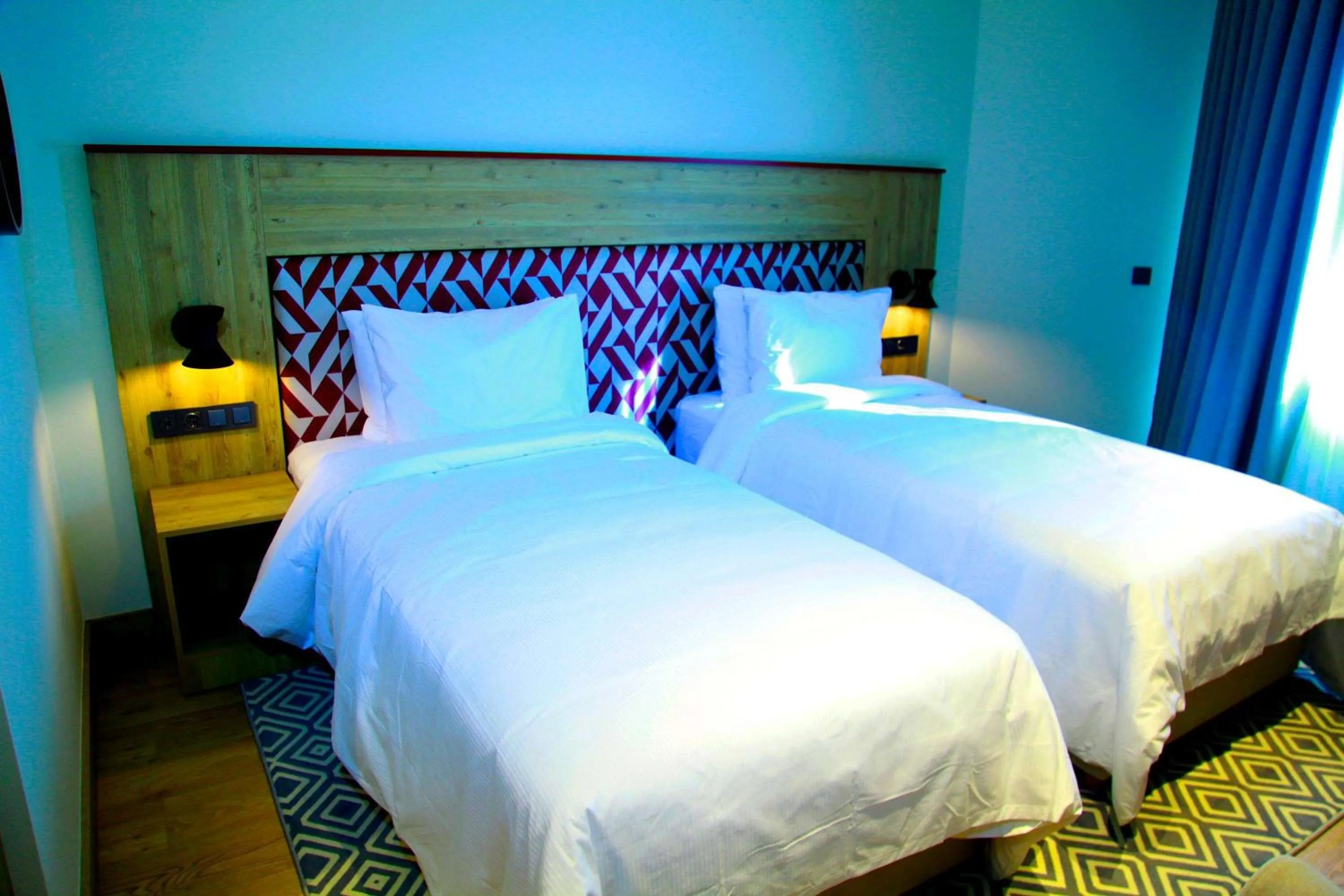 Bed in Ramada Encore by Wyndham Zomin