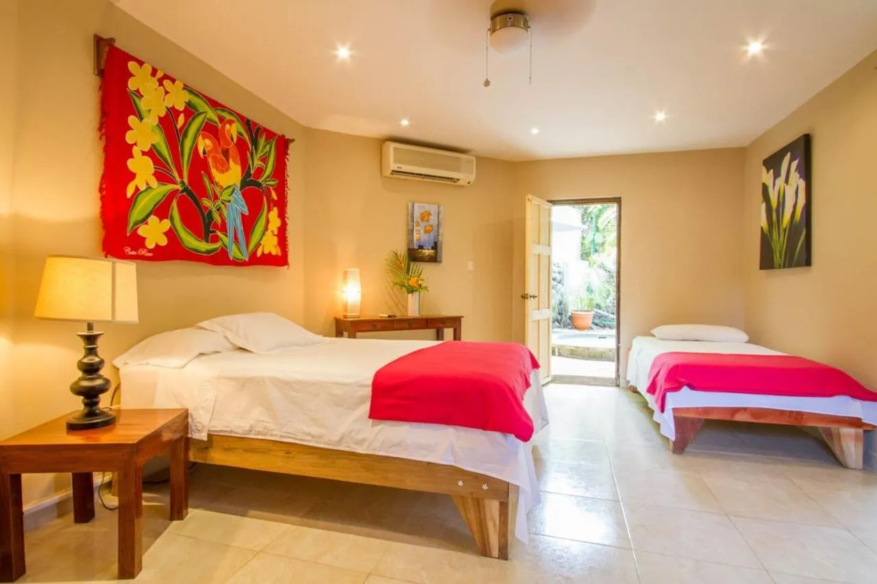 Bed in Tamarindo Village Hotel