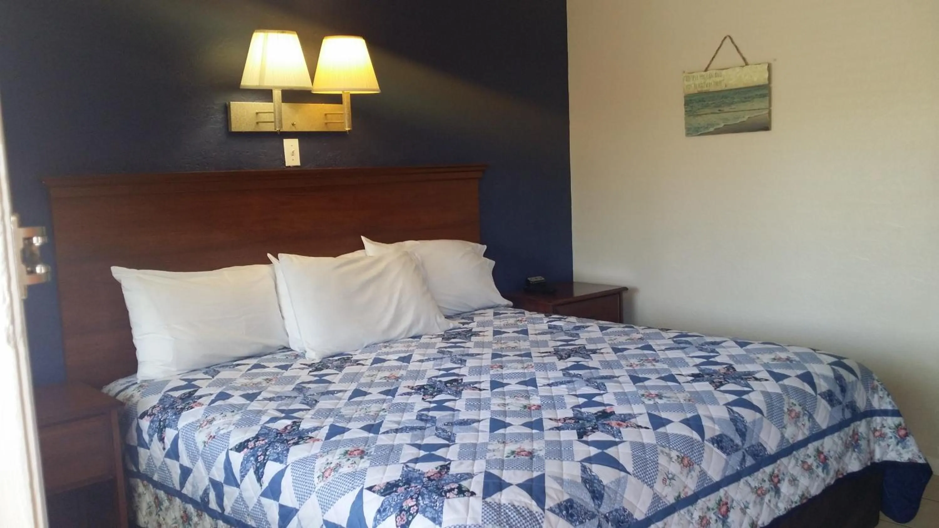 Bed in Palm Breeze Hotel