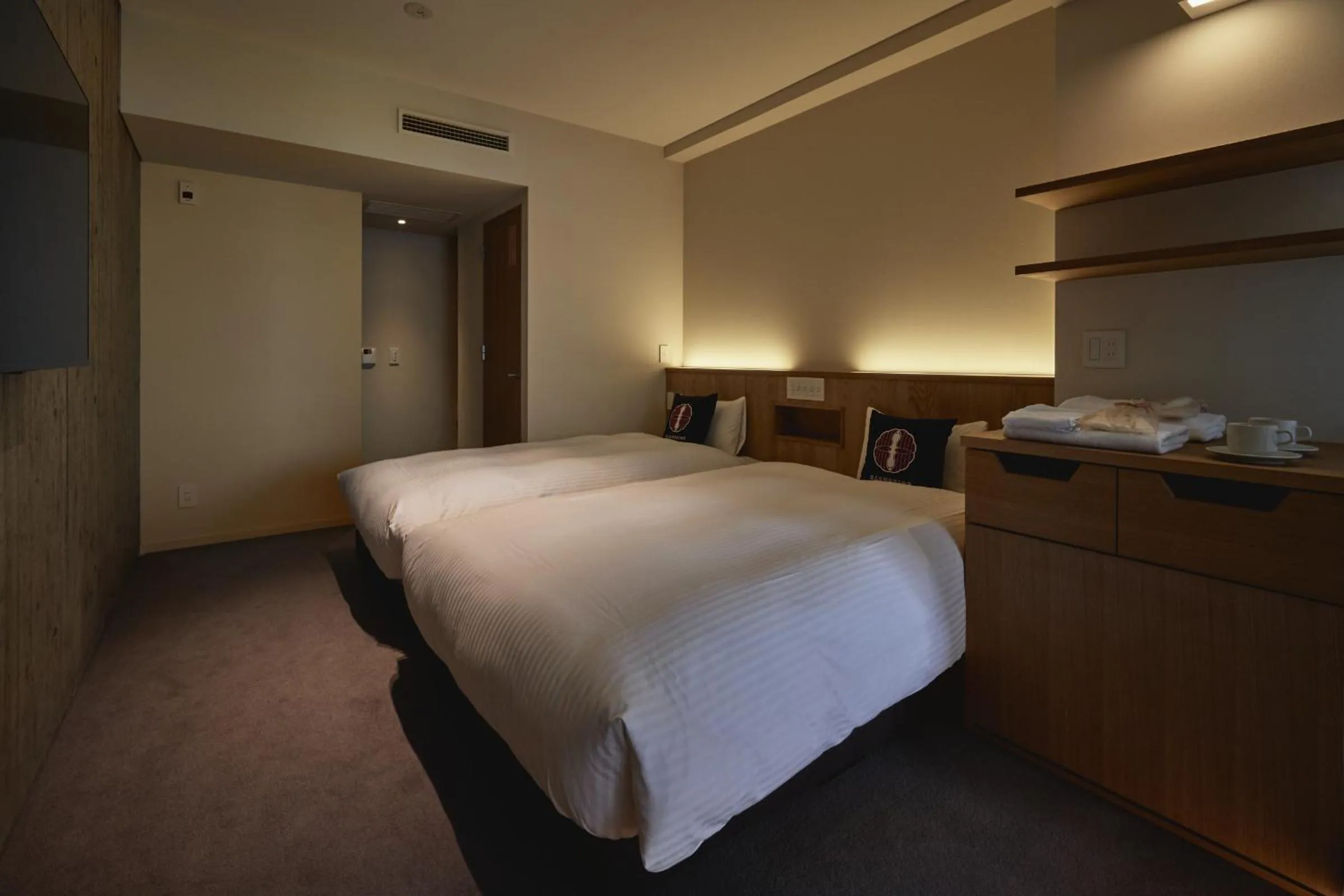 Bed in THE HOTELS HAKATA Harushige Honkan