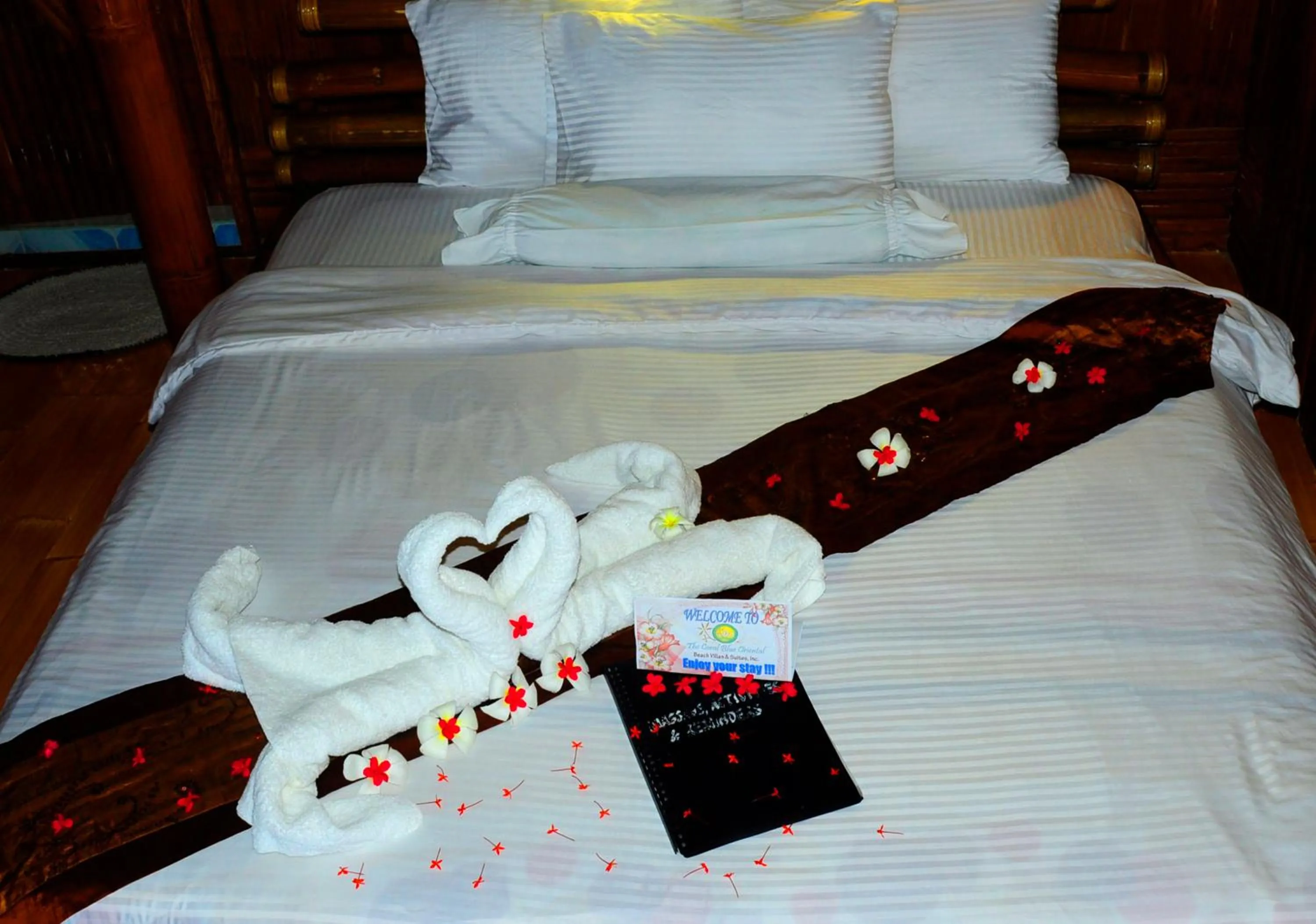 Bed in The Coral Blue Oriental Beach Villas and Suites