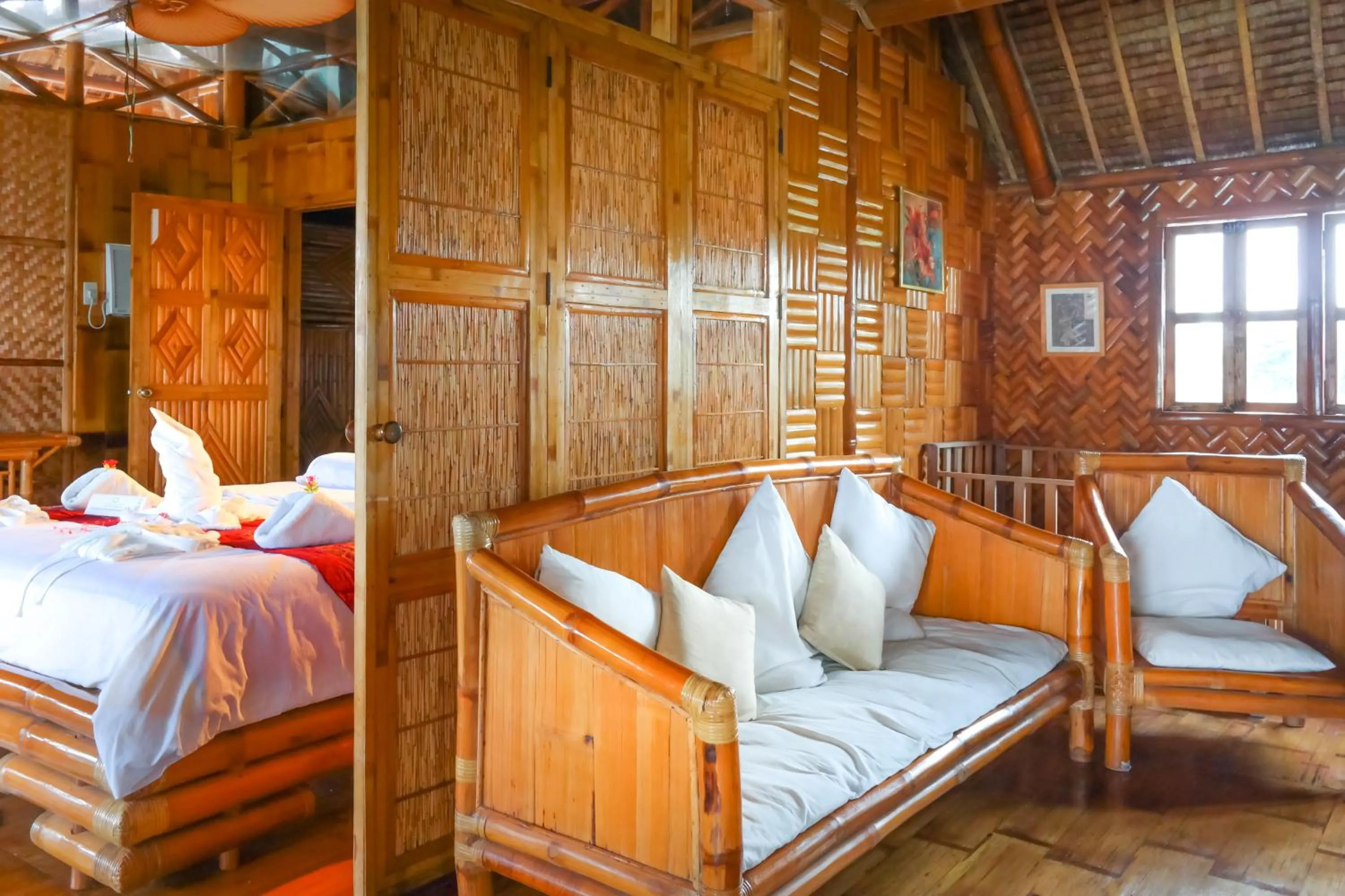 Seating area, Bed in The Coral Blue Oriental Beach Villas and Suites