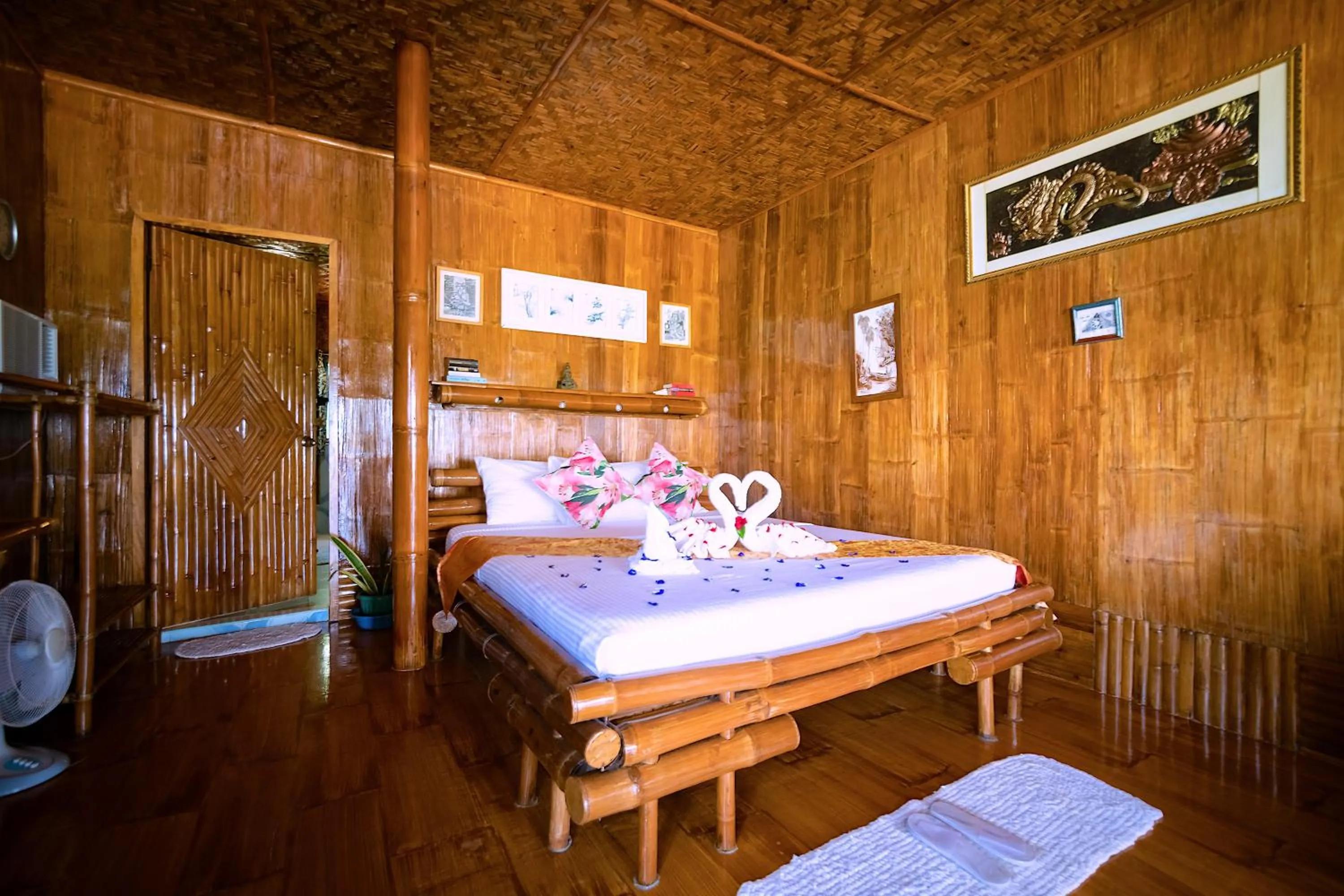 Bed in The Coral Blue Oriental Beach Villas and Suites