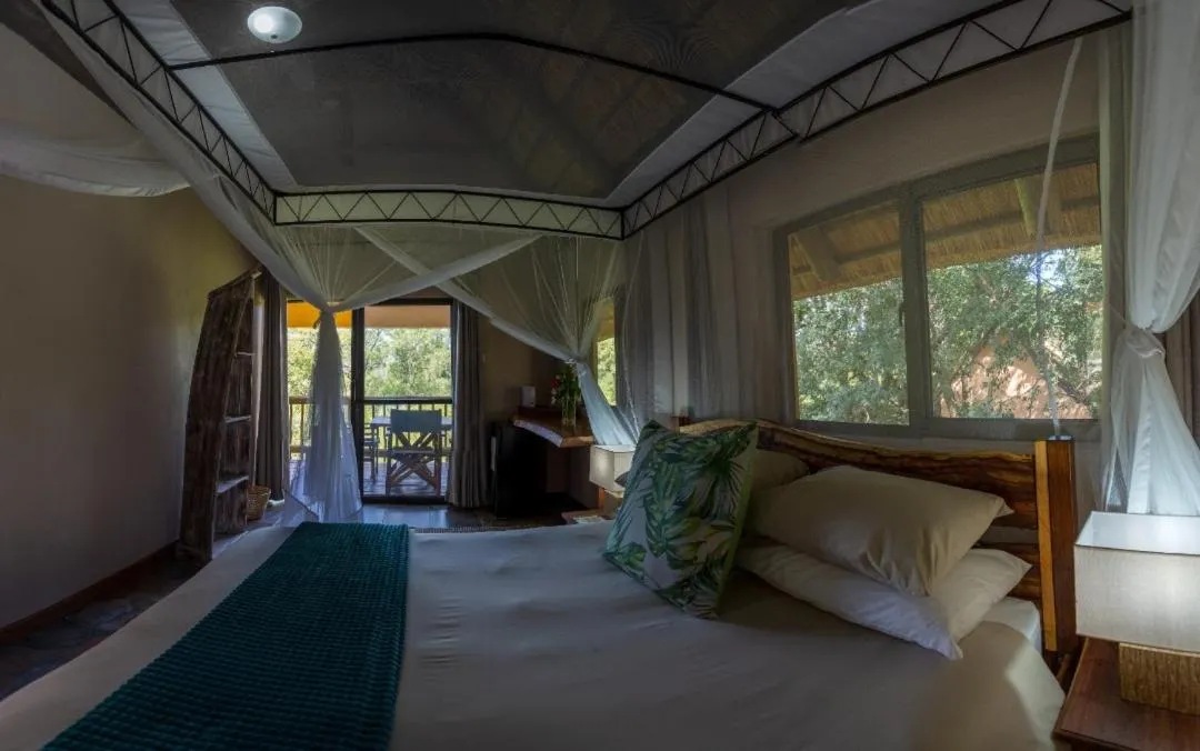 Bed in Maramba River Lodge