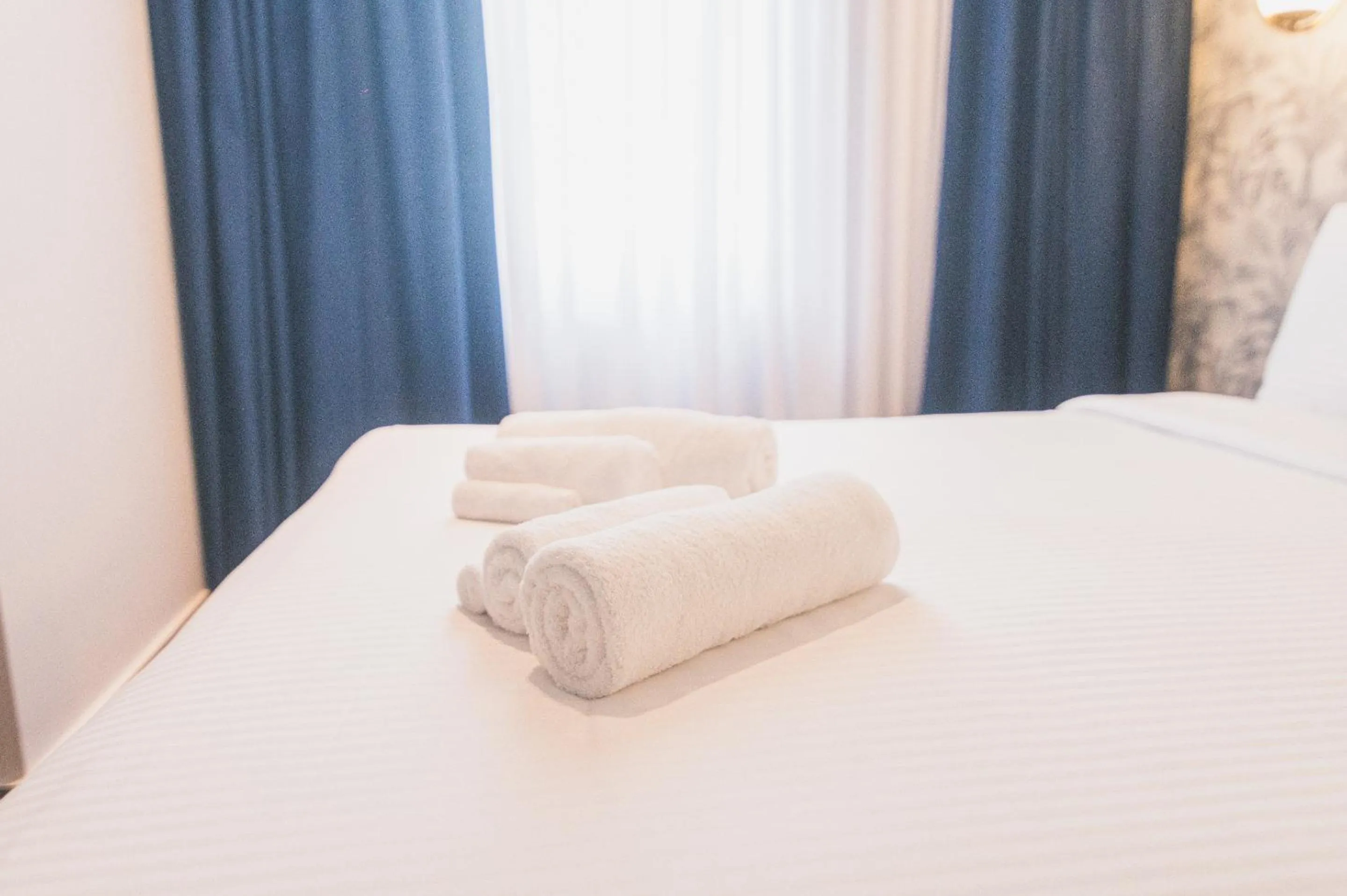 towels, Bed in Downtown Suites by Athens Tower