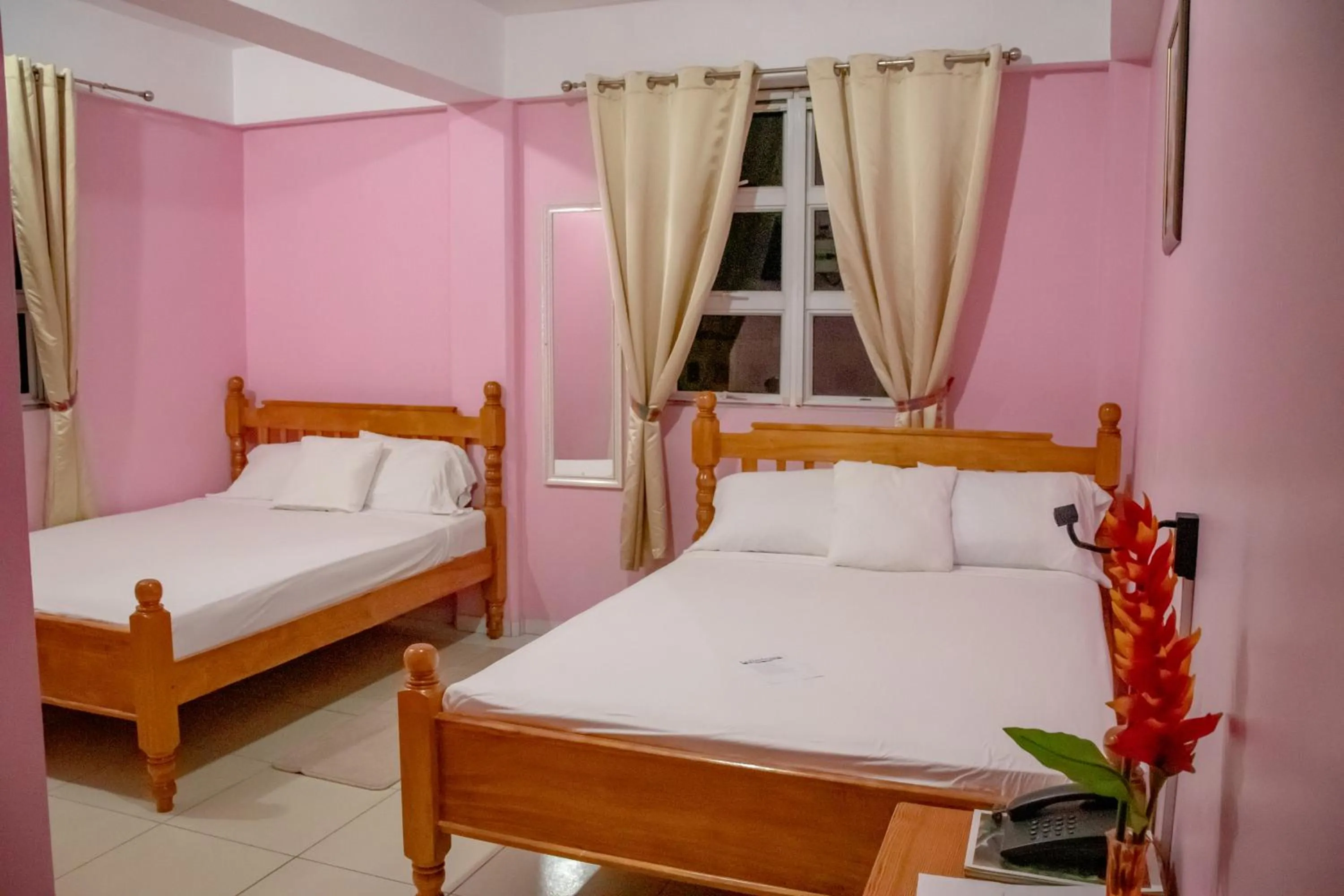 Bed in La Flamboyant Hotel