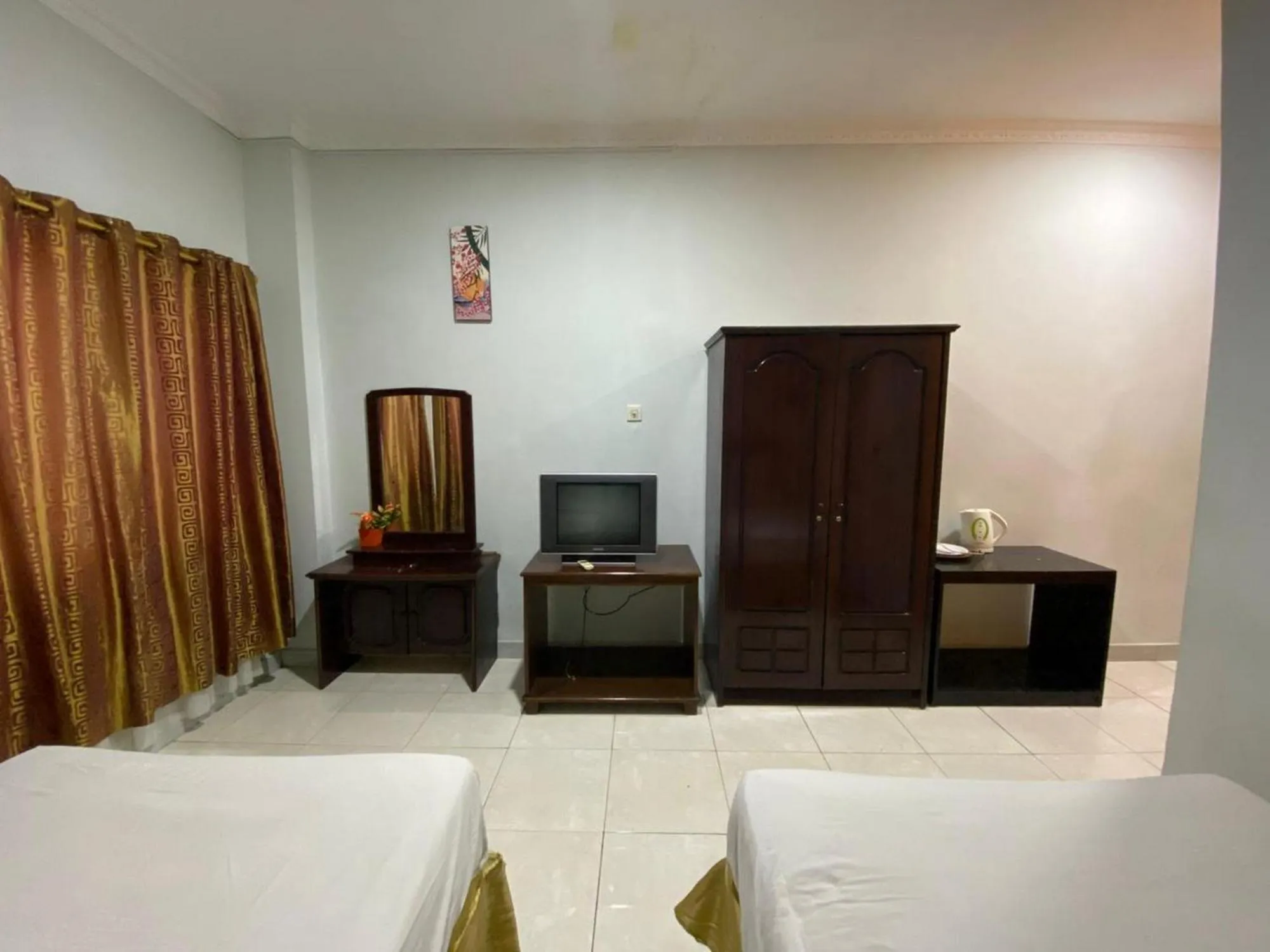 Bed in Hotel Magellona Makassar Mitra RedDoorz