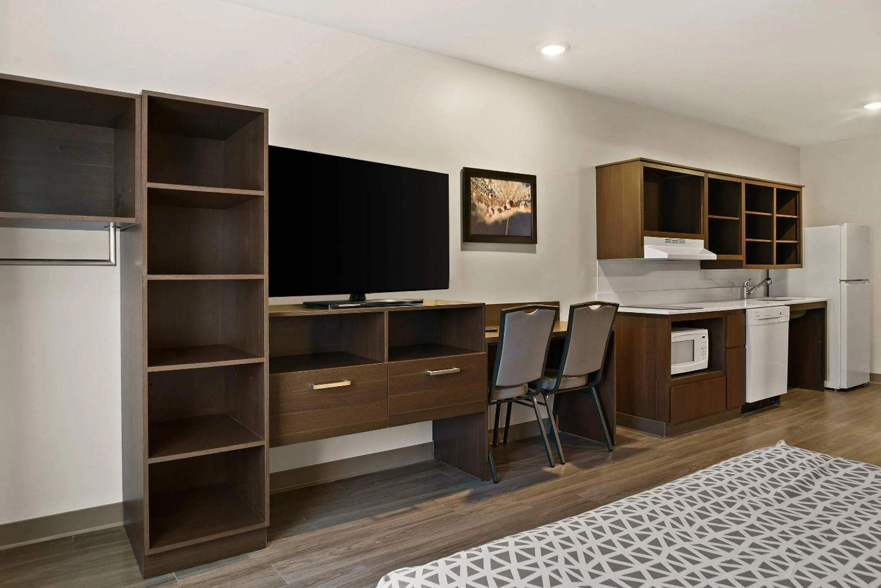 Bedroom in WoodSpring Suites East Lansing - University Area