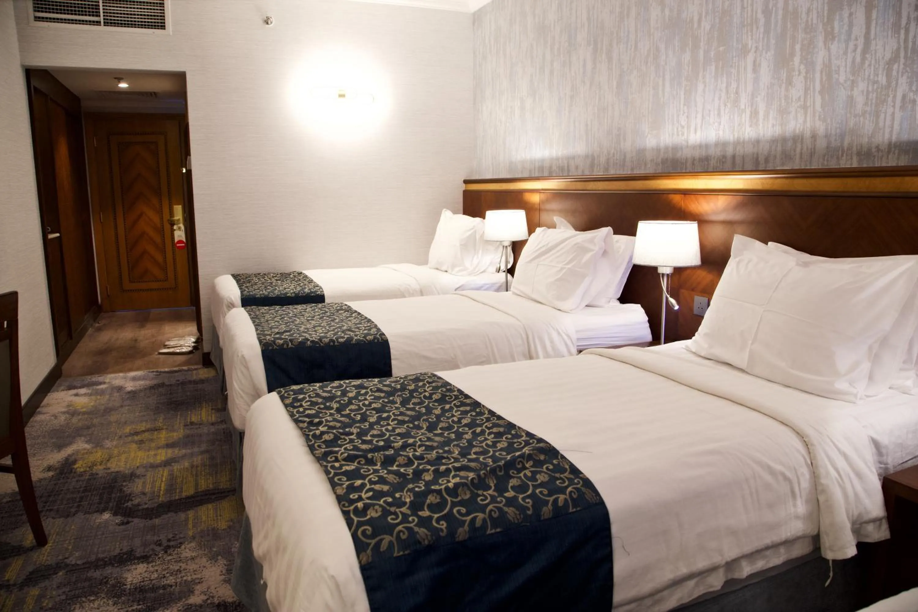 Bed in Nozol Royal Inn Hotel