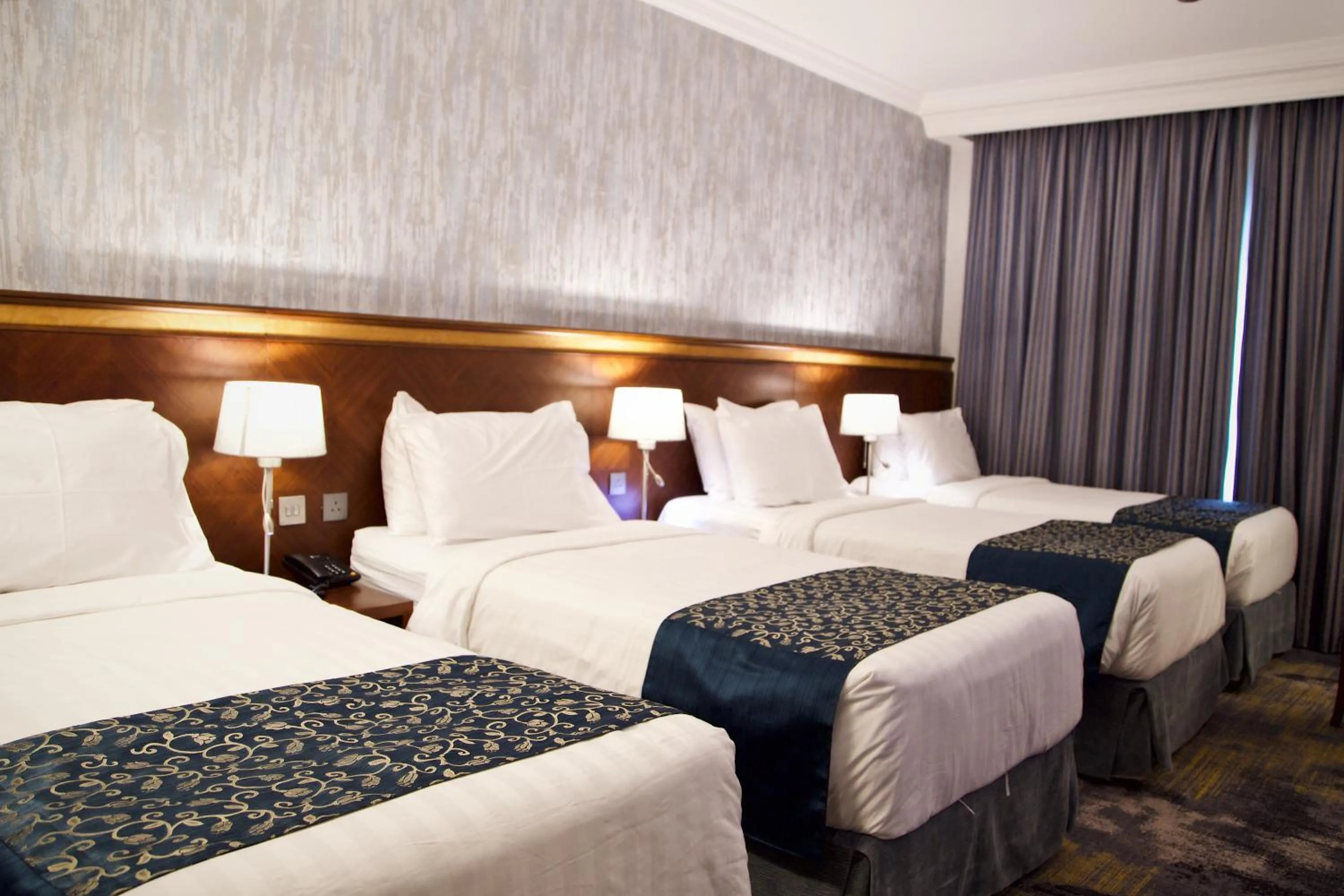 Bed in Nozol Royal Inn Hotel