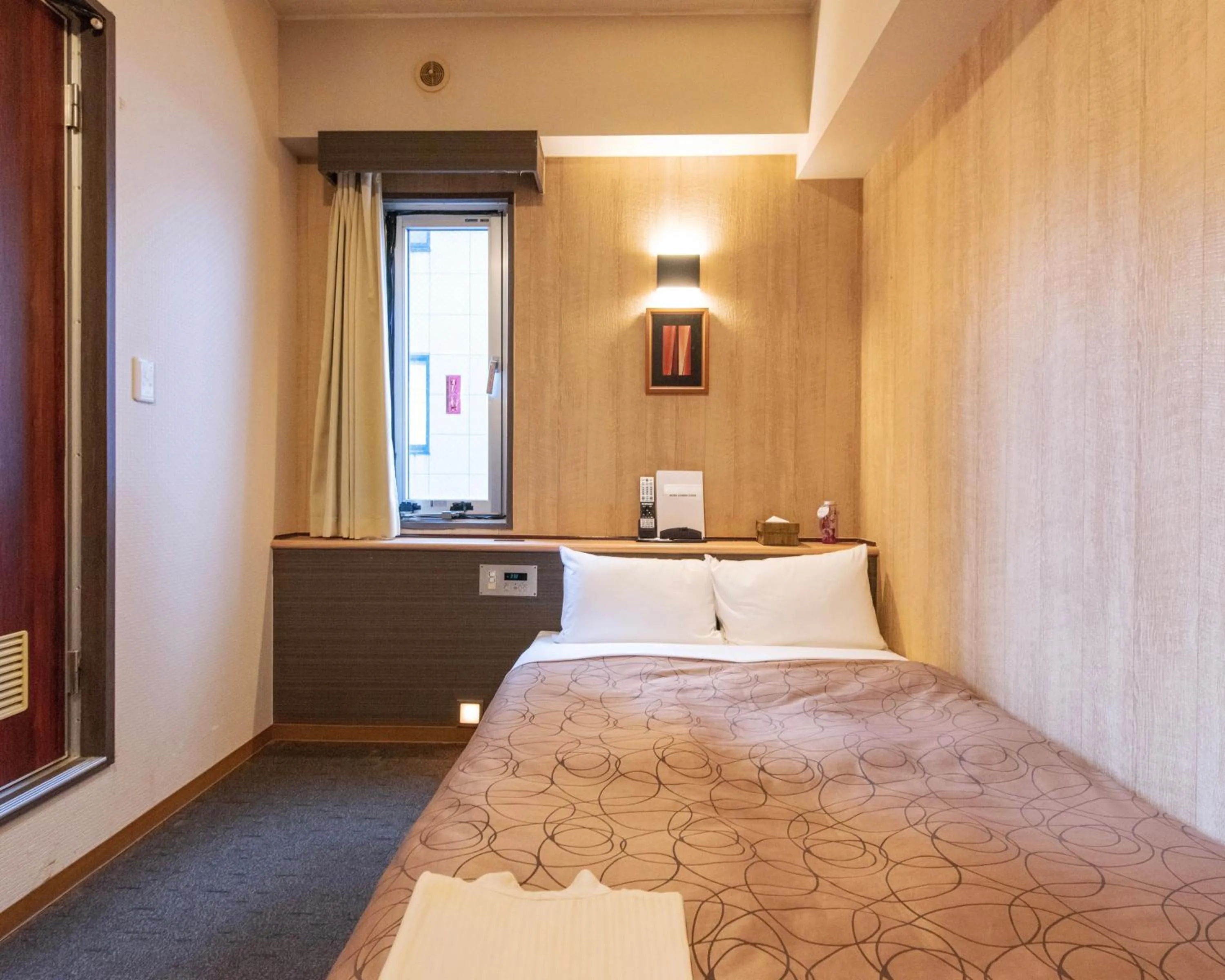 Bed in HOTEL RELIEF Kokura Station