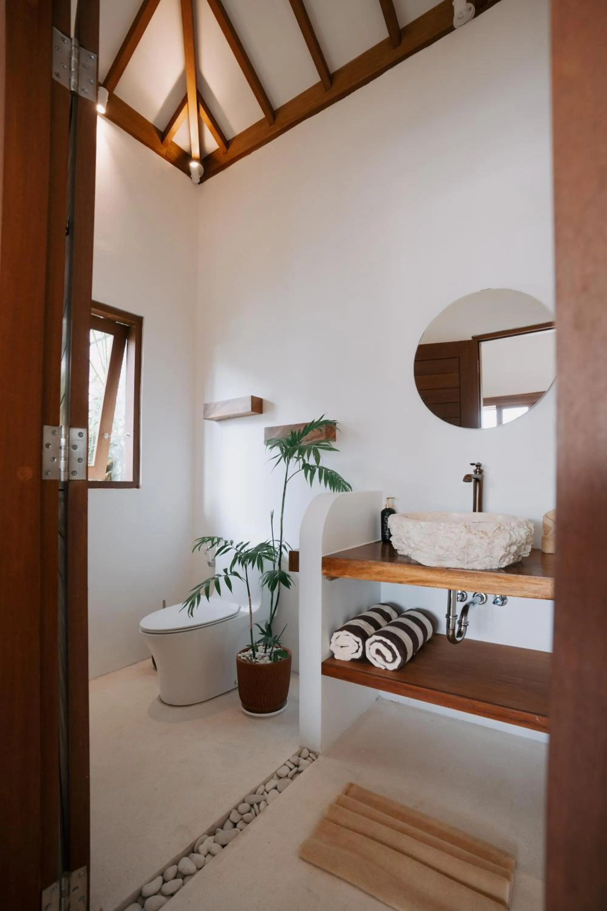 Bathroom in EHOA NYANYI BEACH Boutique Hotel - In front of entrance to NUANU