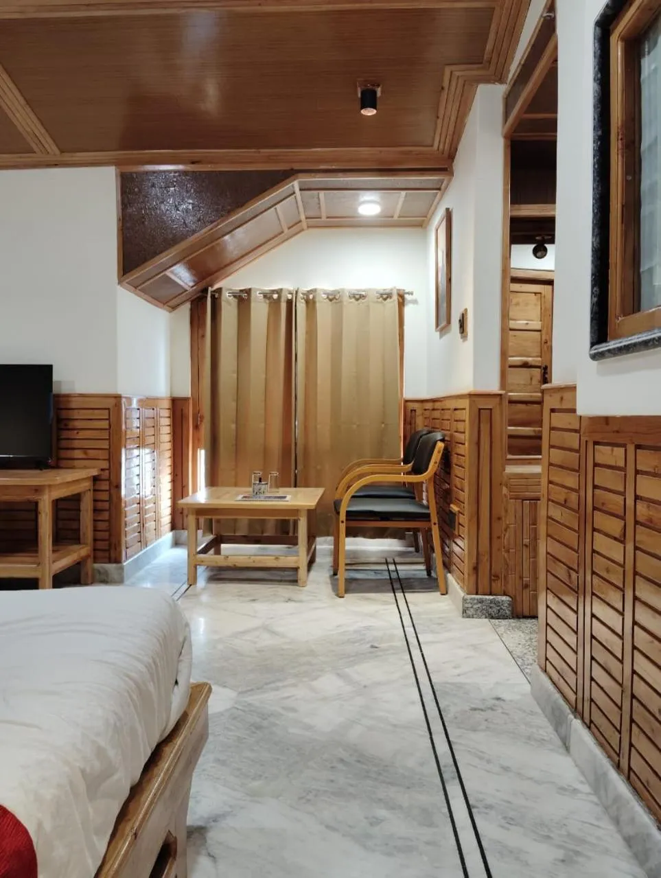 Seating area, Bed in Hotel CM Palace - Pure Vegetarian