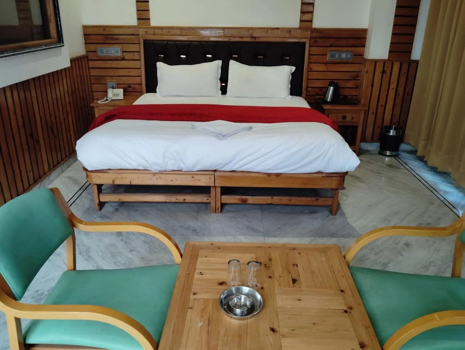 Seating area, Bed in Hotel CM Palace - Pure Vegetarian